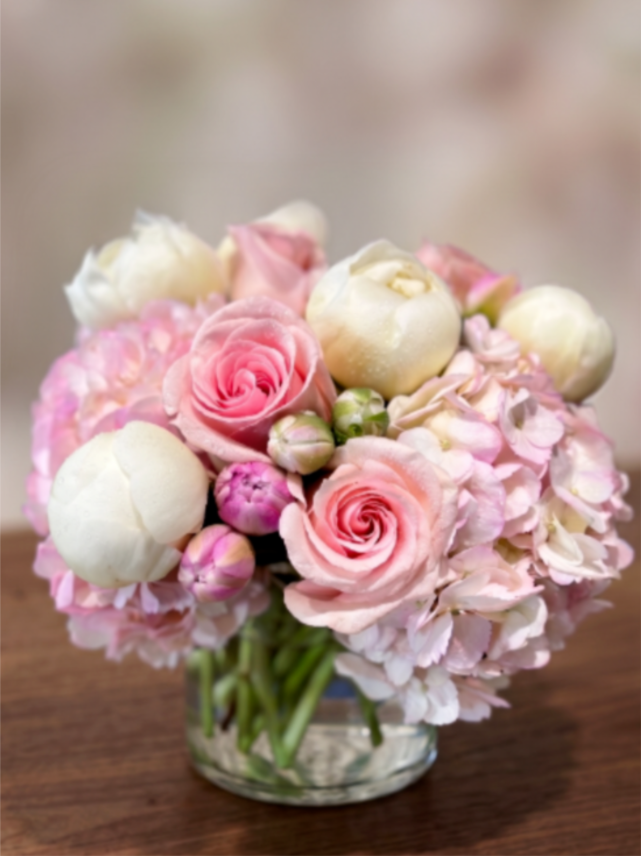 Pink and white bouquet in a clear glass vase