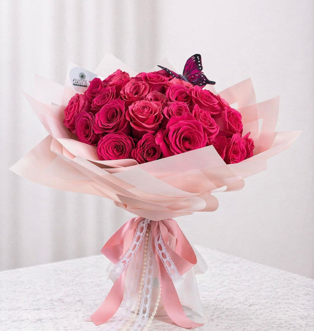 Under Her Wings - A mother's love helps her children take flight and find their own path. This floral bouquet comes with 50 fuchsia roses and two butterflies. 