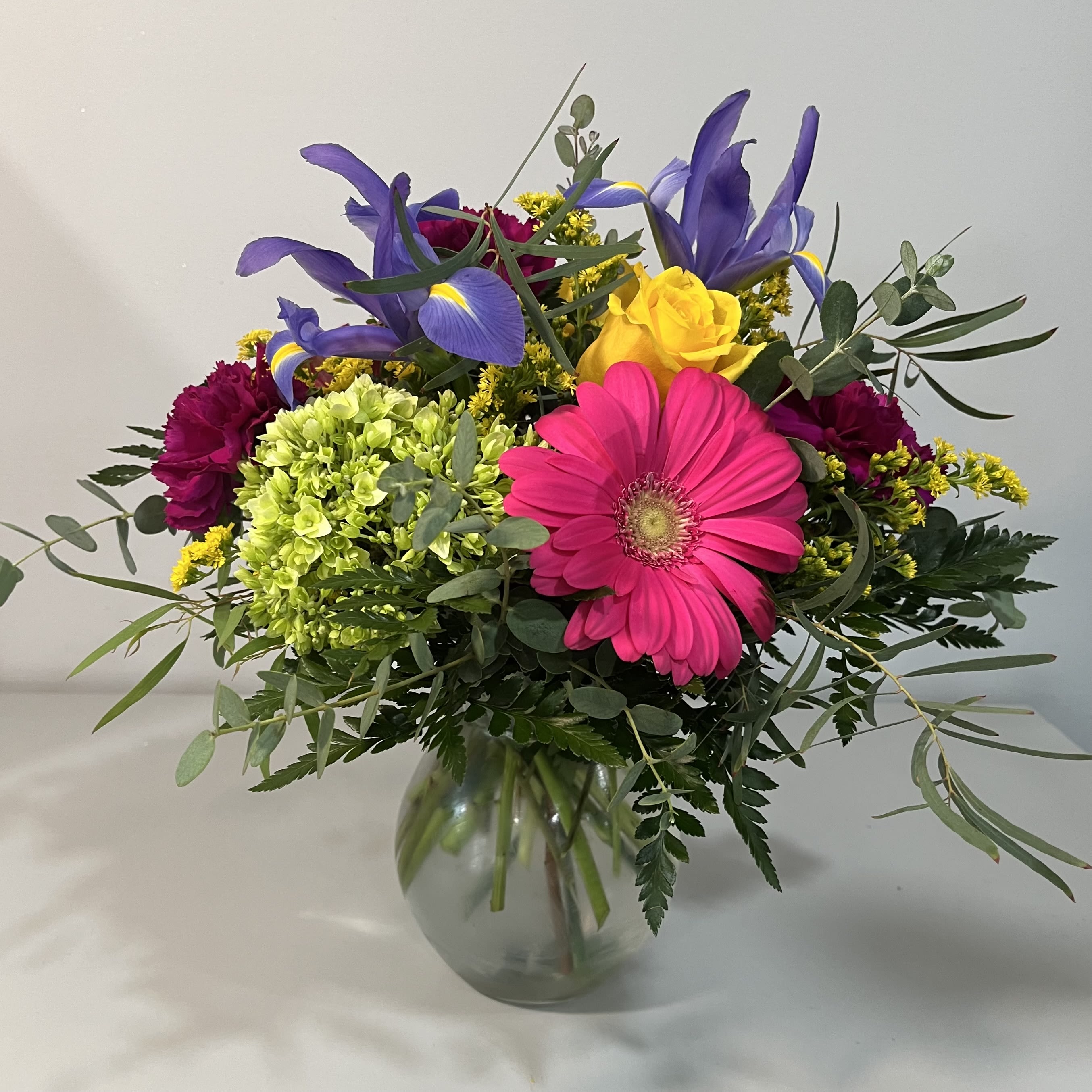 Colorful Surprise - Bright and Colorful mix using Gerbera Daisy, Iris, Green Hydrangea and Yellow Roses, Carnations (product may be different due to availability)
