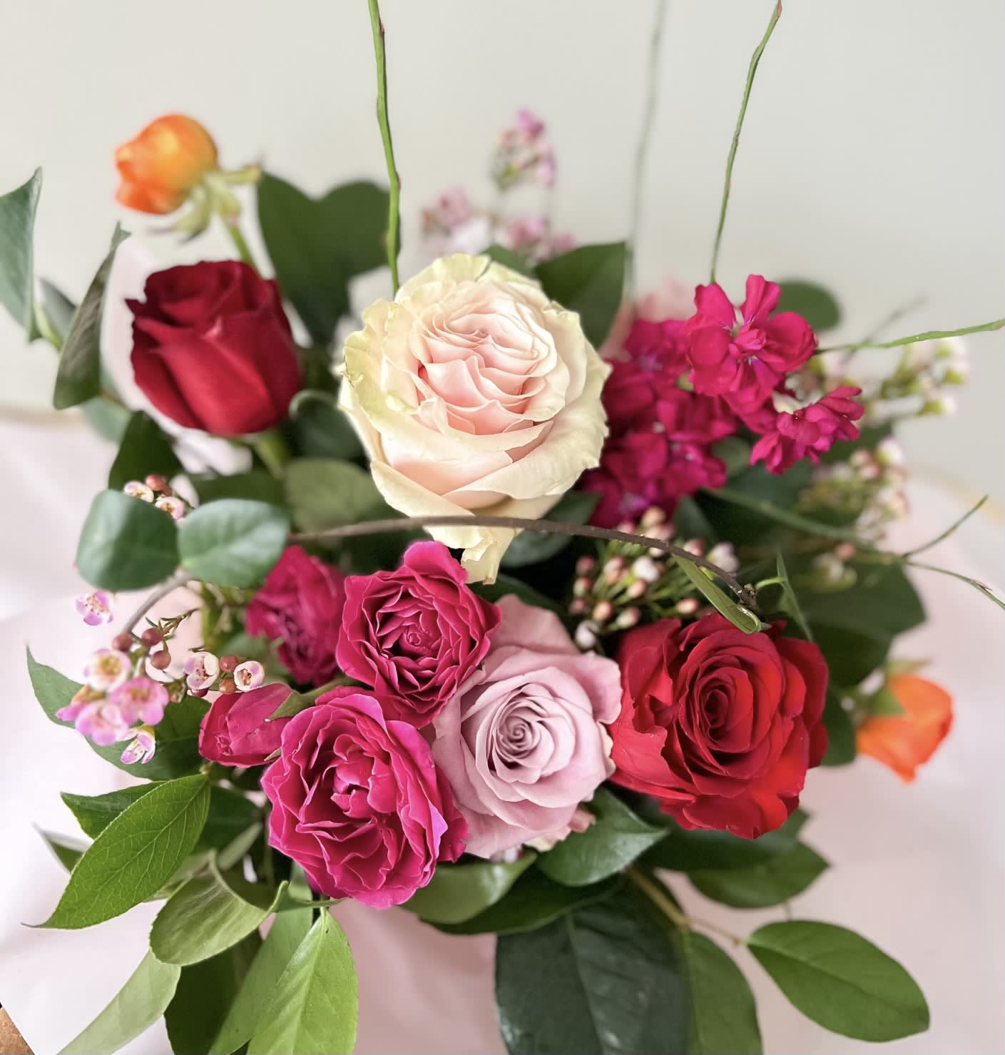 Mixed bouquet of roses in pink, red, and cream tones