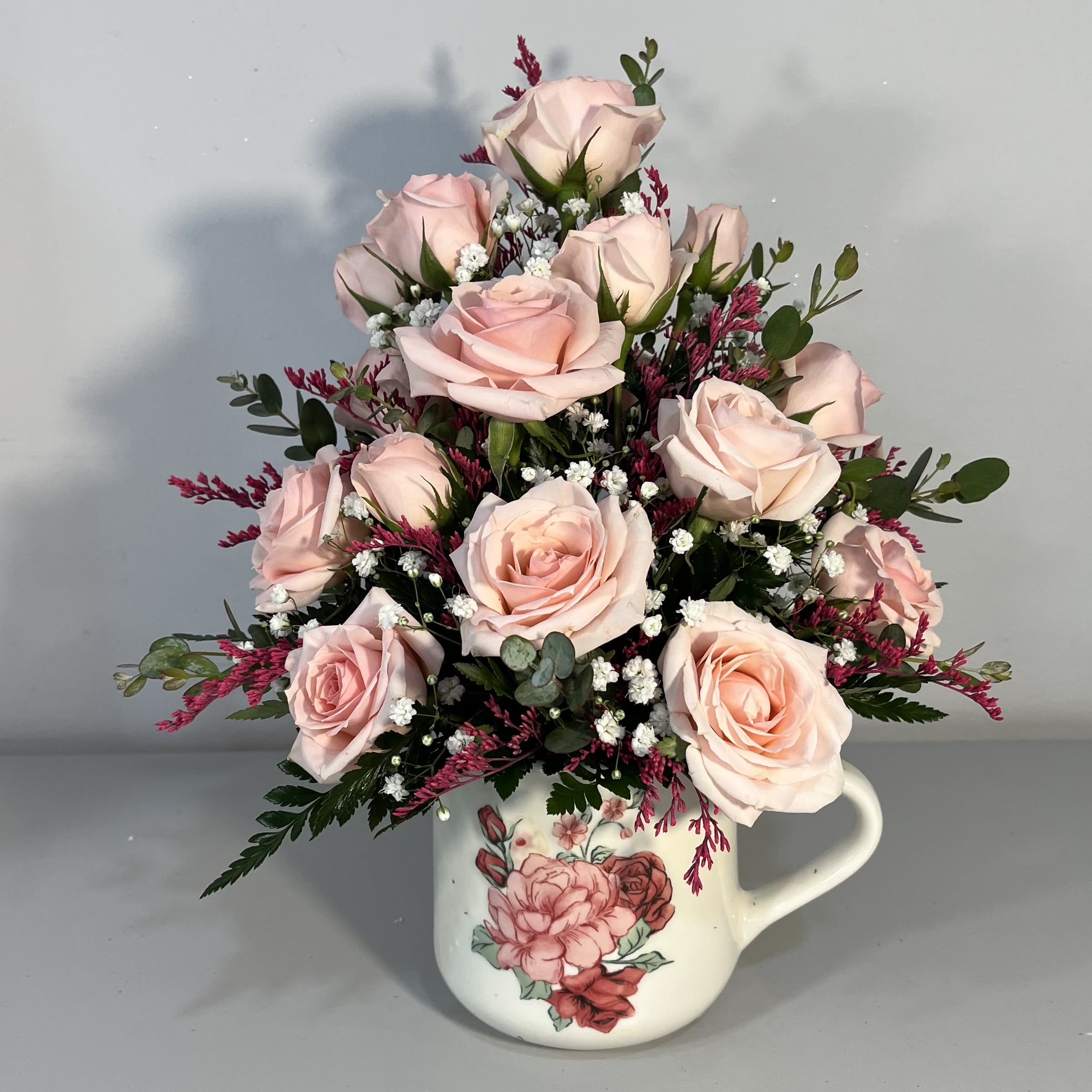 Cup of Love - 20oz. coffee mug filled with blushing pink Sweetheart Spray Roses