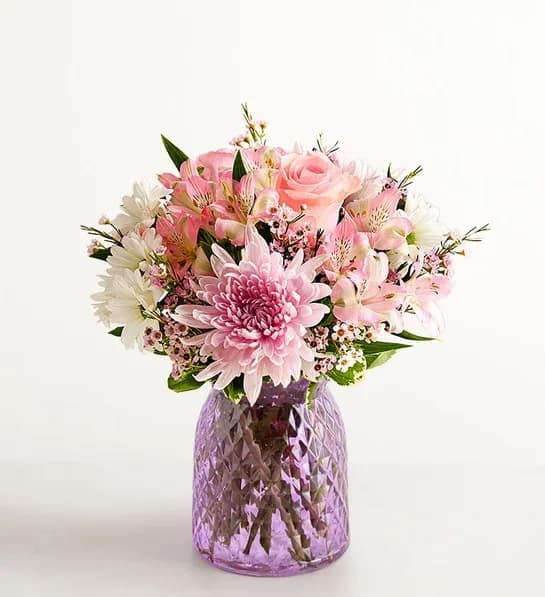 Amazing Mom Bouquet -  You know she’s amazing; now show her that you know. Roses, Peruvian lilies, daisy poms, and other lush blooms arrive artfully arranged in a lavender glass vase, resulting in a gift as beautifully splendid as she is. 