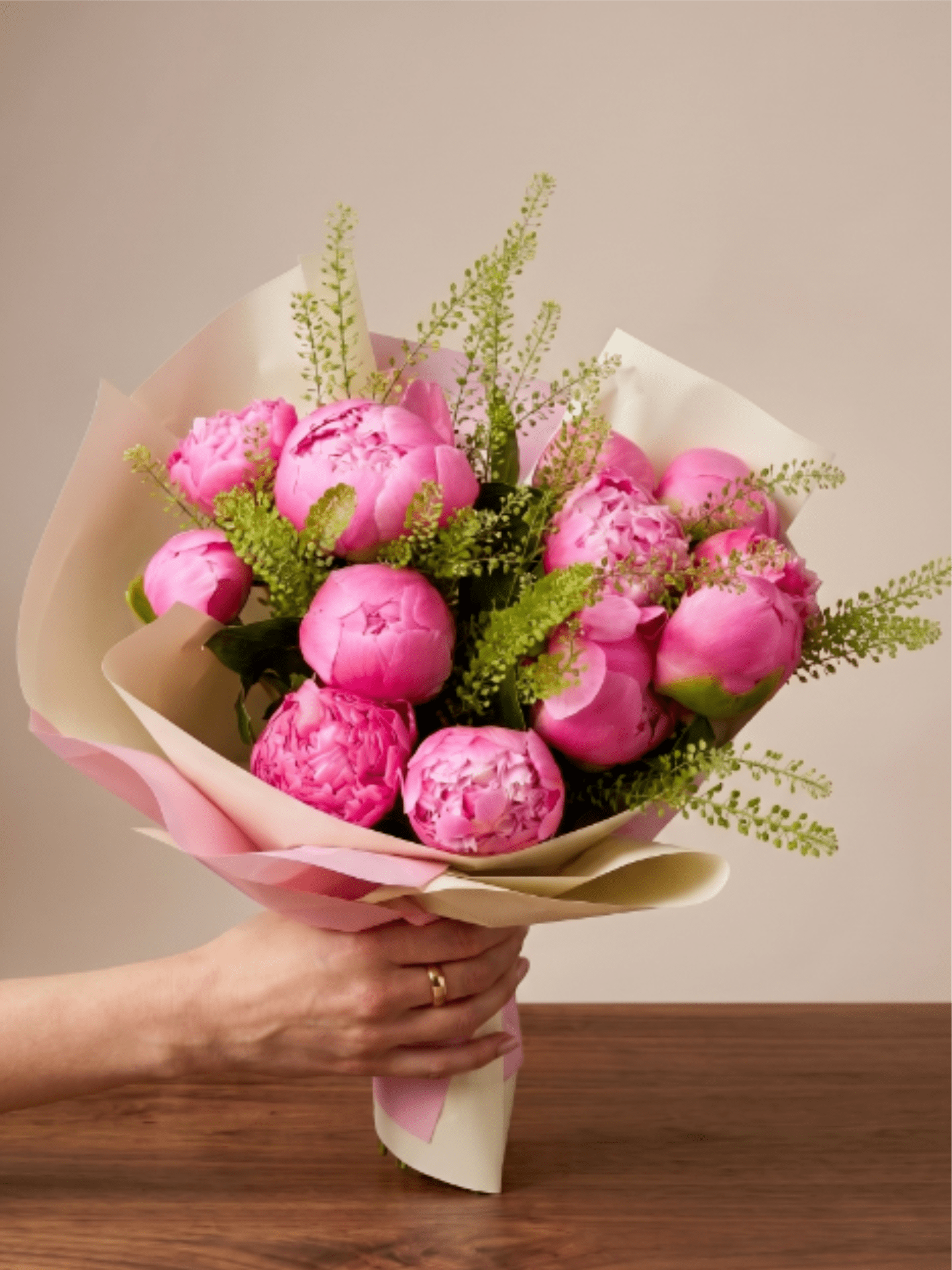 BP114 - Hot Pink Peony Bouquet - It features a striking and luxurious gathering of vibrant pink peonies, elegantly accented with delicate, textured green thlaspi. Bold, lush, and beautifully wrapped, it’s the ideal gesture for celebrating life's most beautiful moments.  Featured Blooms &amp; Seasonality:  Peonies: Peak late Spring through early Summer.  Thlaspi (Green Bell): Peak Spring and Summer.