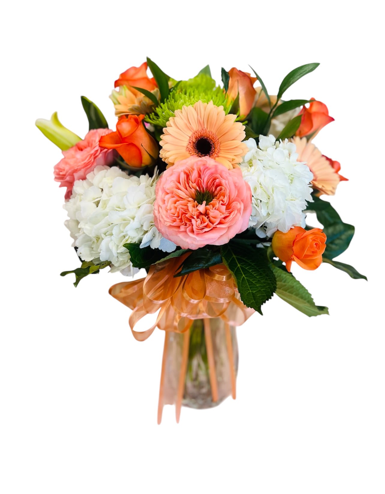 Peachy Day - A bright peach gerbera takes center stage in this rounded flower arrangement, a joyful choice for a Mother's Day bouquet or any birthday celebration that should feel warm and personal. The peach, orange, pink, white, and green palette reads as cheerful and fresh-the kind of bouquet that makes the person you're thinking of feel genuinely celebrated the moment it arrives.  This flower arrangement combines coral and peach roses, ruffled pink carnations, white hydrangea clusters, and a single bright green chrysanthemum accent for lively contrast. Flowers are gathered into a clear glass vase and finished with an orange ribbon that echoes the warm tones. The compact, rounded design sits comfortably on a table or desk and showcases a pleasing mix of textures: soft hydrangea clouds, velvety rose petals, and the bold, smooth face of the gerbera.  Perfect for sending to a mother, friend, or colleague who deserves a sunny pick-me-up, Peachy Day reads as both festive and thoughtful without feeling overdone. Standard care-fresh water in the vase and trimming stems every few days-will help the blooms stay vibrant for as long as possible.
