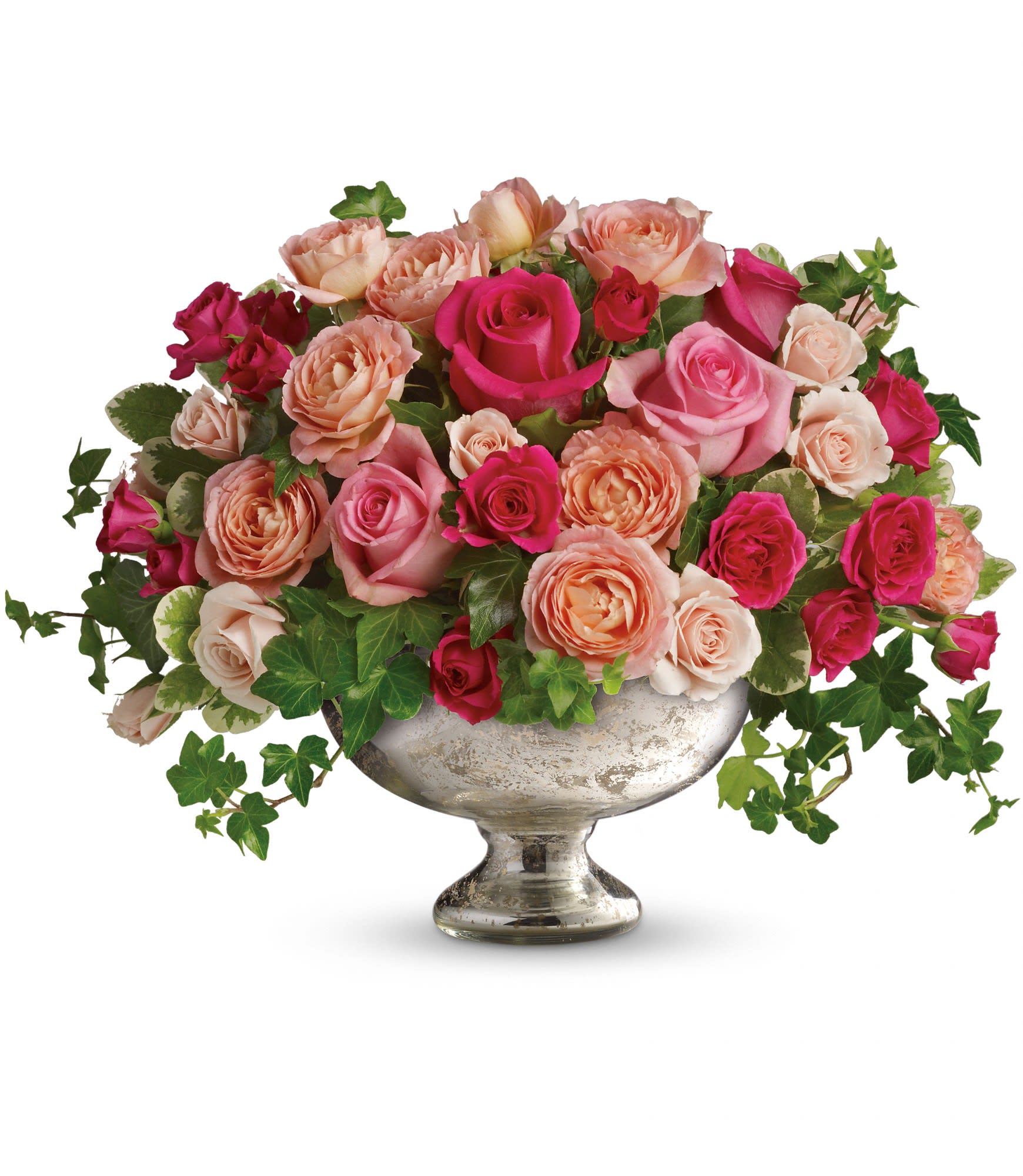 Mixed pink and peach roses arranged in a silver pedestal vase