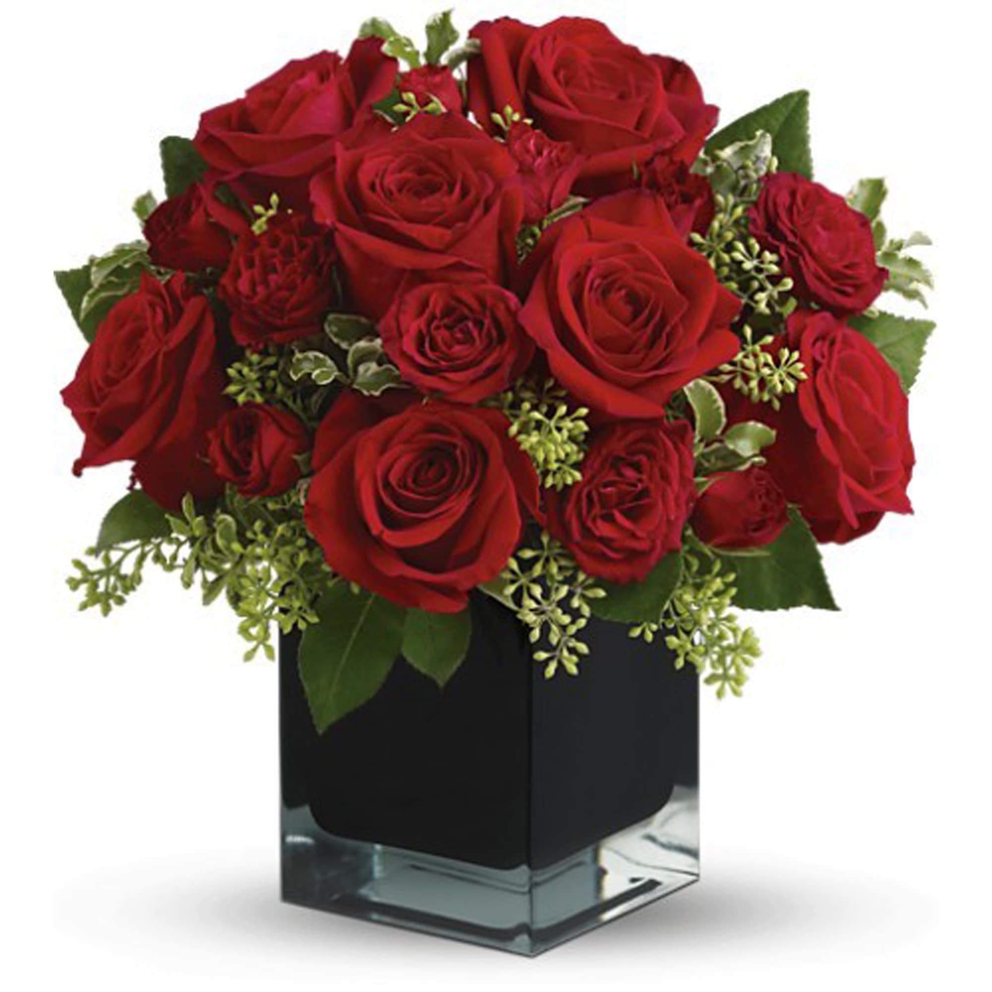 Red roses arranged in a square glass vase with greenery