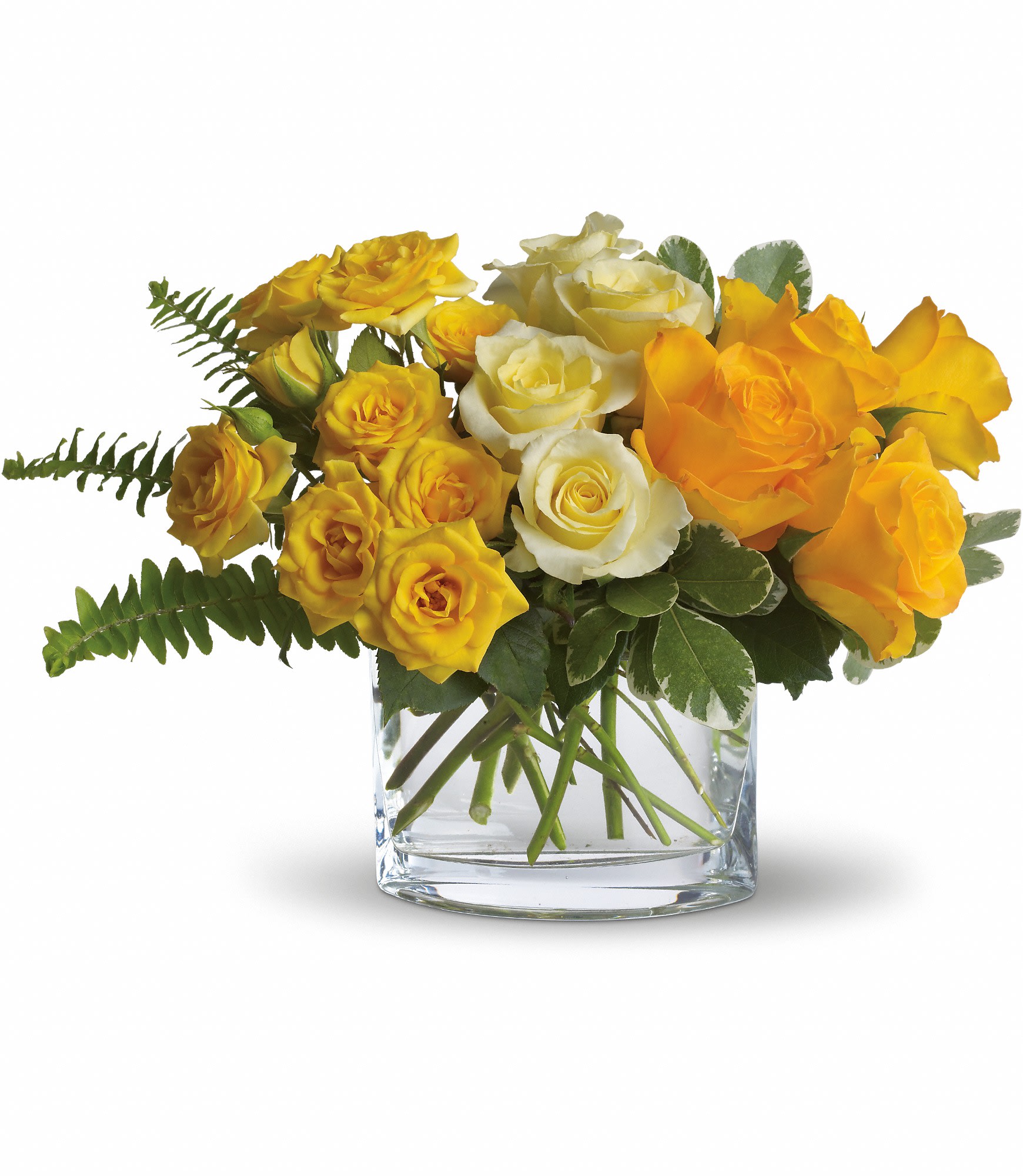 Yellow and white roses arranged in a clear glass vase