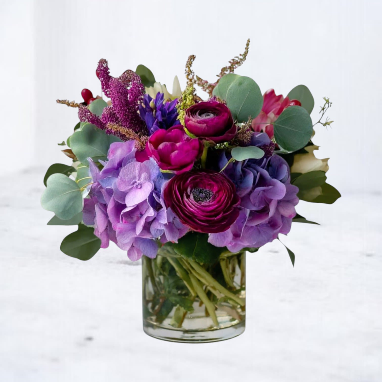 Purple Garden - Purple Garden evokes a sense of whimsy and magic, much like a fairy-tale garden filled with beautiful flowers. The combination of purple hydrangea, ranunculus, hyacinth, and veronica creates a perfect blend of colors and textures perfectly captures the beauty and charm of the arrangement. This would be a great name for any occasion