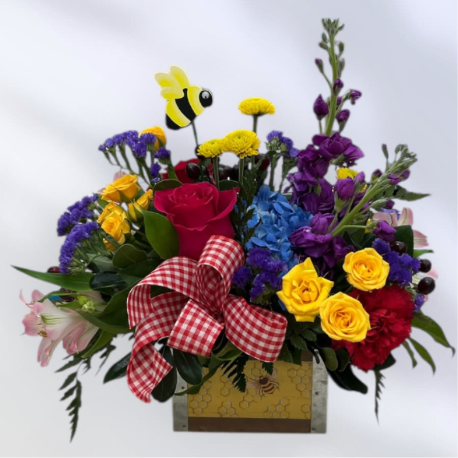 MD57 Queen Bee - Bee ready to enjoy this fresh colorful floral arrangement that includes roses, stock, hydrangea, and other beautiful flowers. It comes in a fun bee container accented with ribbon and novelty bobbing bee.