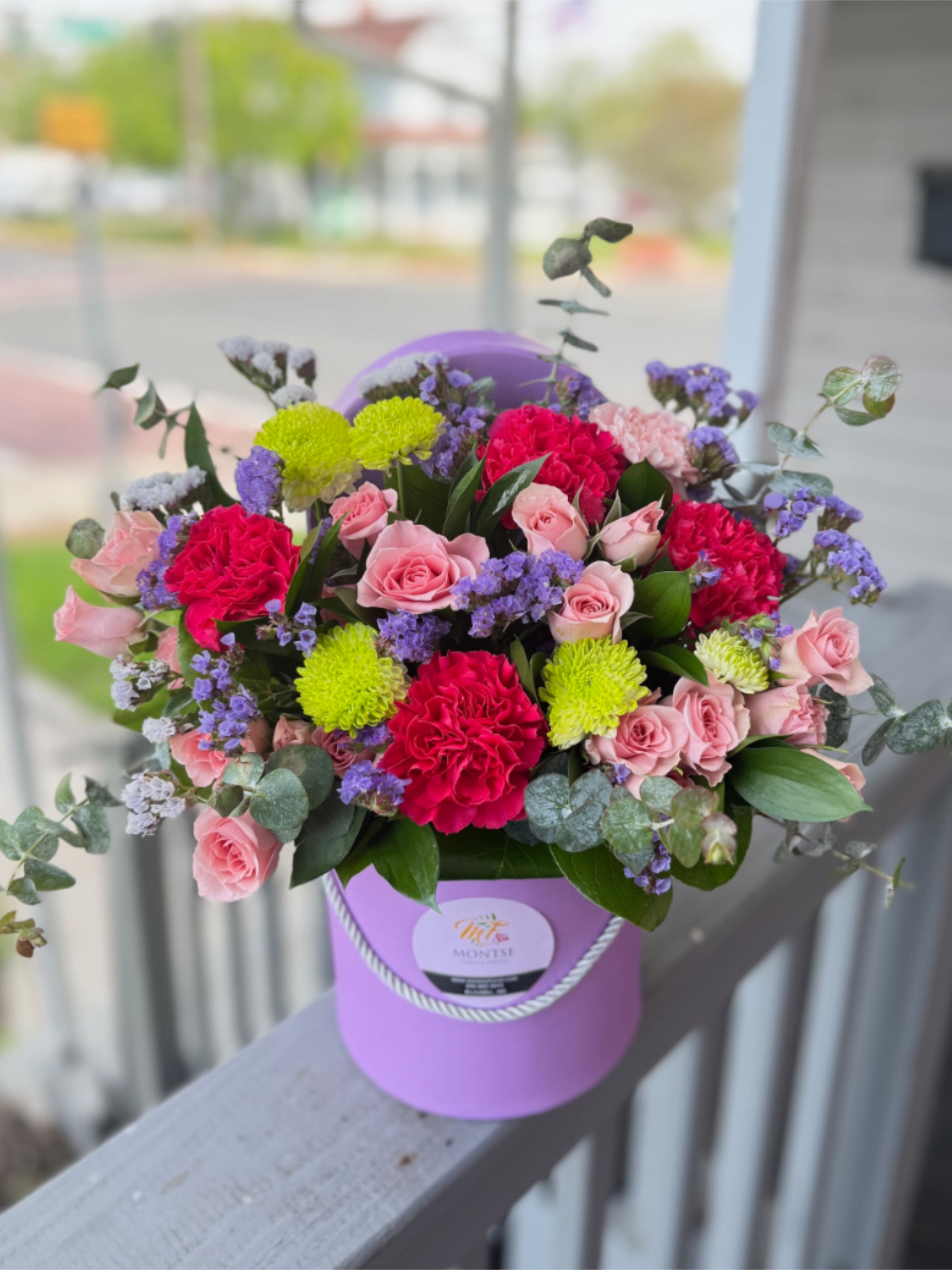Sophia  - Lavender hatbox of blush roses, fuchsia carnations and chartreuse chrysanthemums, lavender statis with eucalyptus accents