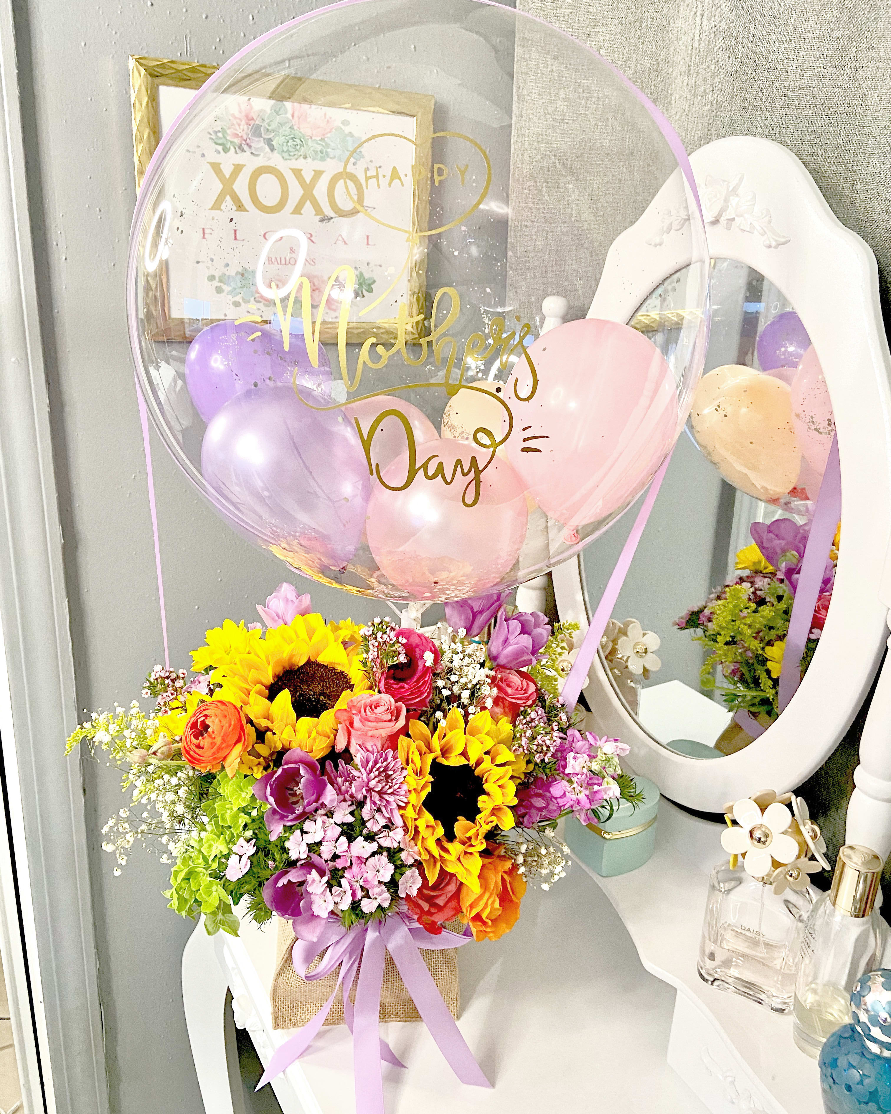 Luxury Happy Mother’s Day  - Beautiful bubble balloon “happy Mother’s Day”  filled with spring flowers that represents the special women who helped you become the person you are today.  This boxed arrangement contain a mix bouquet of spring flowers!!