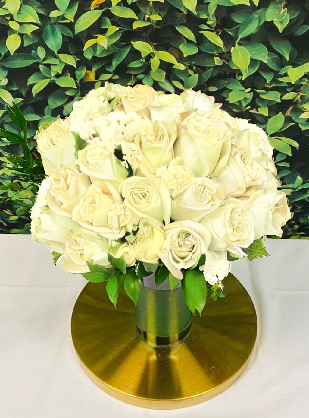 Two Dozen White Roses with Luxe Floral Gift Wrap and Personalized Card - Two dozen pristine white roses, selected for life's celebrated milestones. Their soft fragrance, paired with touches of greenery and filler blooms, creates an atmosphere of serene elegance. Your personal message provides the final, heartfelt touch to this graceful arrangement.