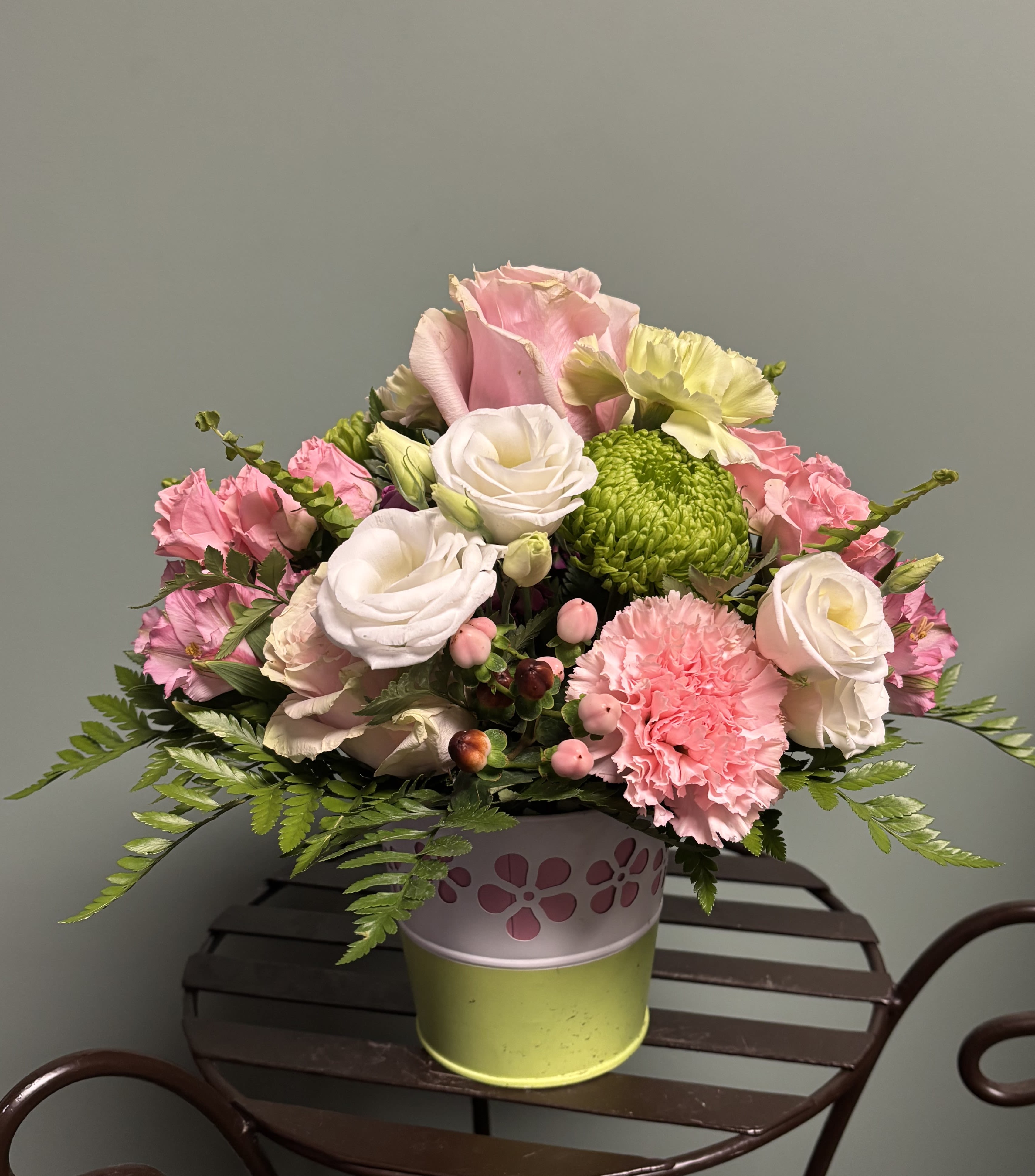 One Great Mom! - The striking green, and white tin has a contrasting pink floral cutout. This delightful arrangement will be filled with coordinating blooms and fillers to create a masterpiece splash of color coordinating wonder!  A great Mother's Day gift!!