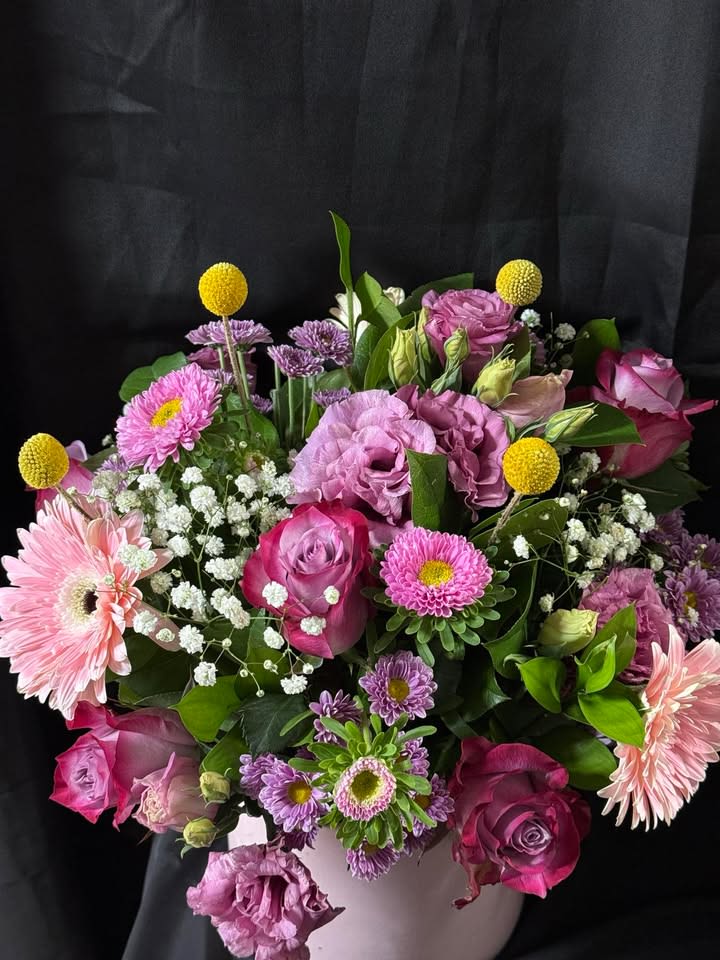 Pink and purple mixed bouquet in a white vase