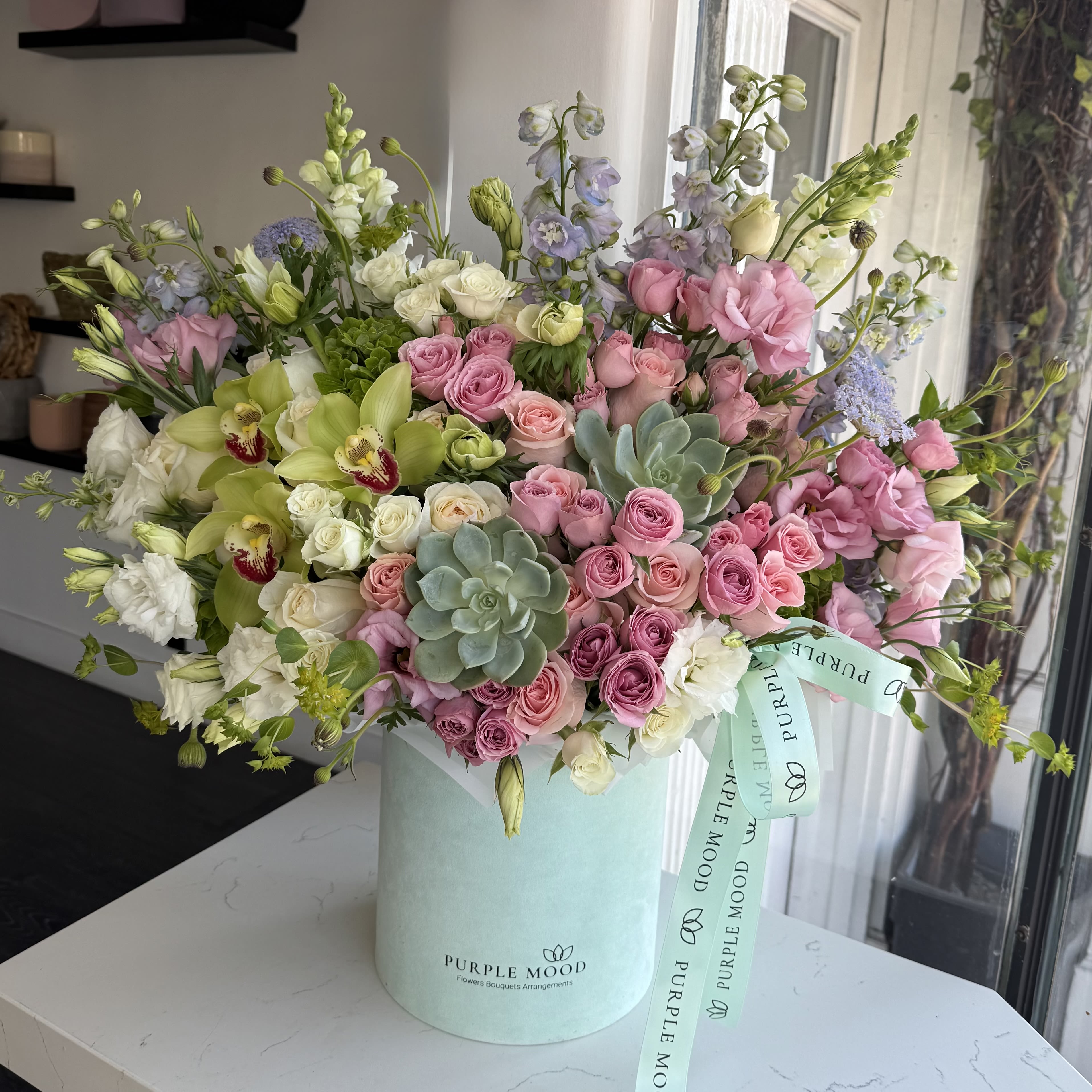 Large pastel bouquet in a mint box with pink and white flowers
