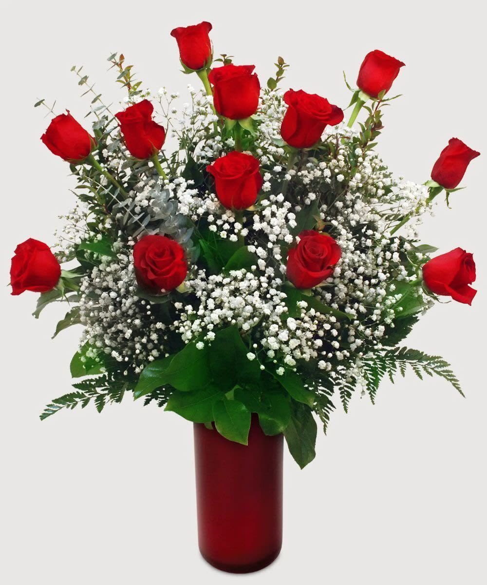 Classic  Red Rose Vase for Mom - A luxurious arrangement of fresh red roses accented with greenery and soft golden details, designed in a classic red glass vase. This timeless piece brings warmth, elegance, and romance to any celebration or special moment.