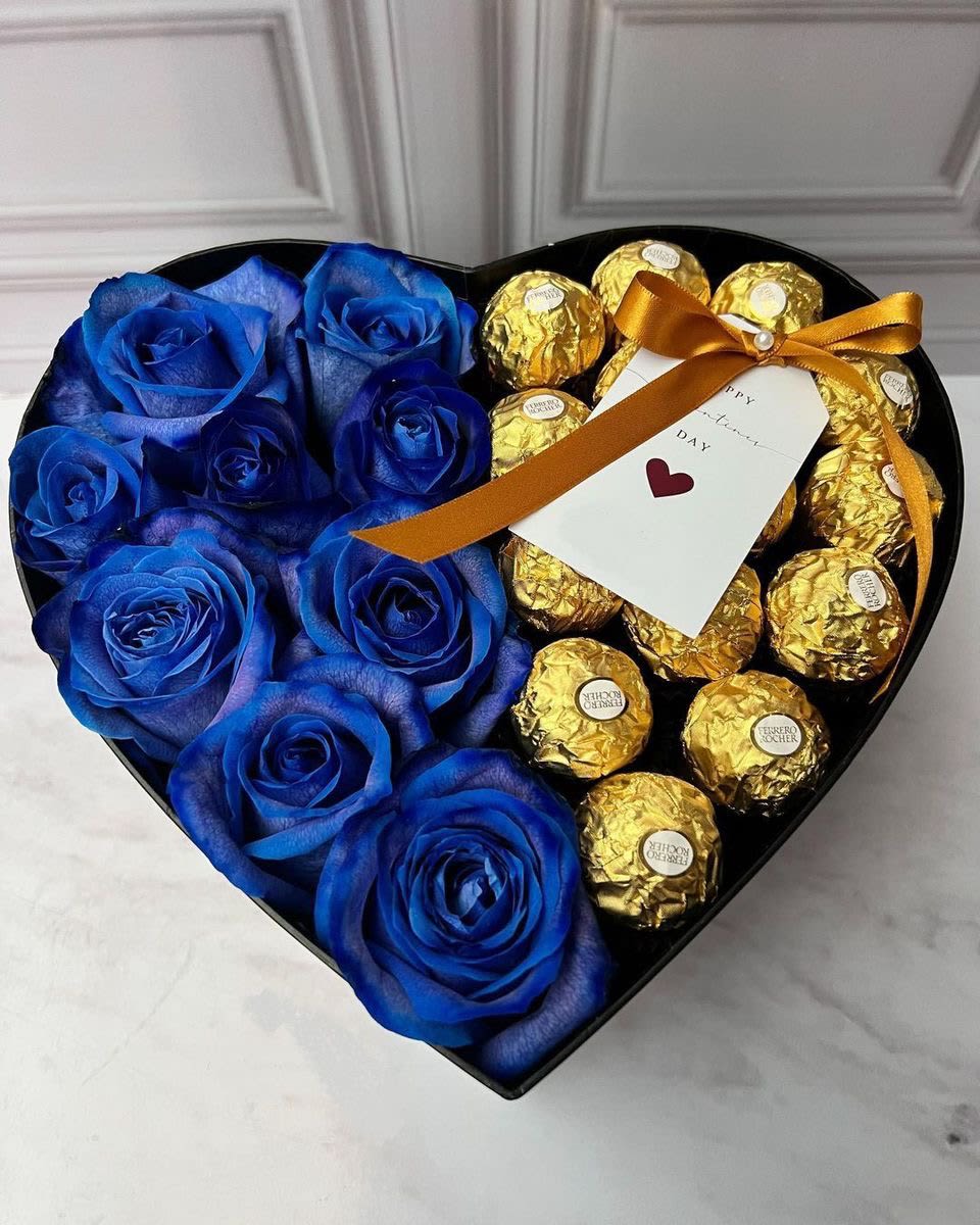 Heart-shaped box with blue roses and gold-wrapped chocolates