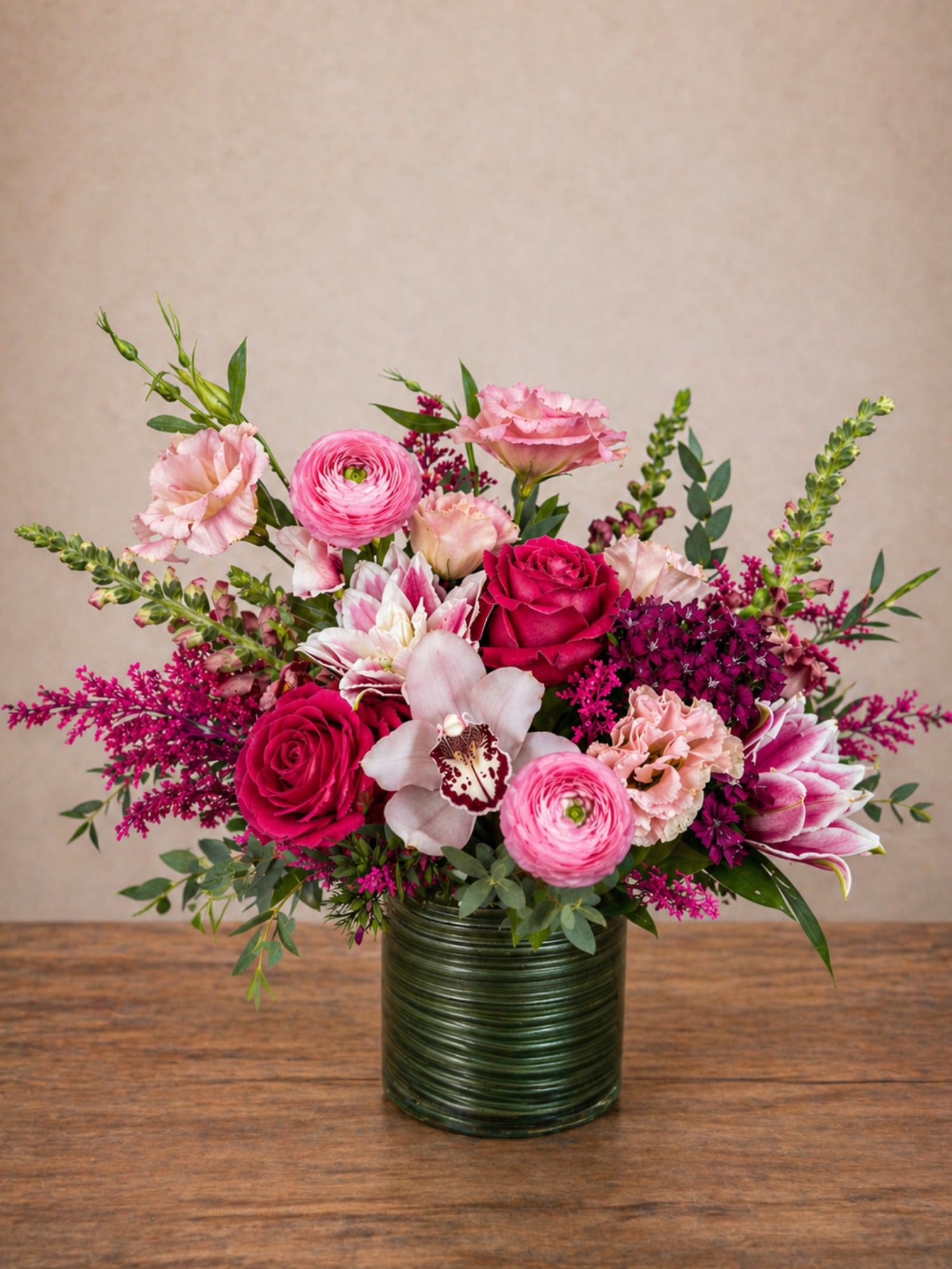 Blushing Garden – Roses, Ranunculus, Lilies &amp; Orchid Arrangement - Looking for a ranunculus, roses, and orchid arrangement in Round Rock, TX? Blushing Garden by Floral Fabulous features a lush mix of ranunculus, roses, double lilies, and orchids with same-day flower delivery available.  Perfect for Mother’s Day, birthdays, anniversaries, or special occasions, this elegant arrangement is handcrafted by your trusted local florist on Mays Street in Round Rock and delivered throughout the Austin area.  Blushing Garden is a luxurious, garden-inspired design featuring premium blooms arranged in a modern glass container with lush greenery and vibrant accents. The blend of soft textures and bold color creates a rich, romantic look that feels both refined and full of life.  We proudly offer same-day flower delivery in Round Rock, Pflugerville, Hutto, Georgetown, and surrounding areas, making it easy to send a meaningful gift when it matters most.   Ranunculus, roses, double lilies, and orchids  Bright, romantic, garden-style design  Modern glass container  Perfect for Mother’s Day and special occasions  Same-day delivery available in Round Rock, TX