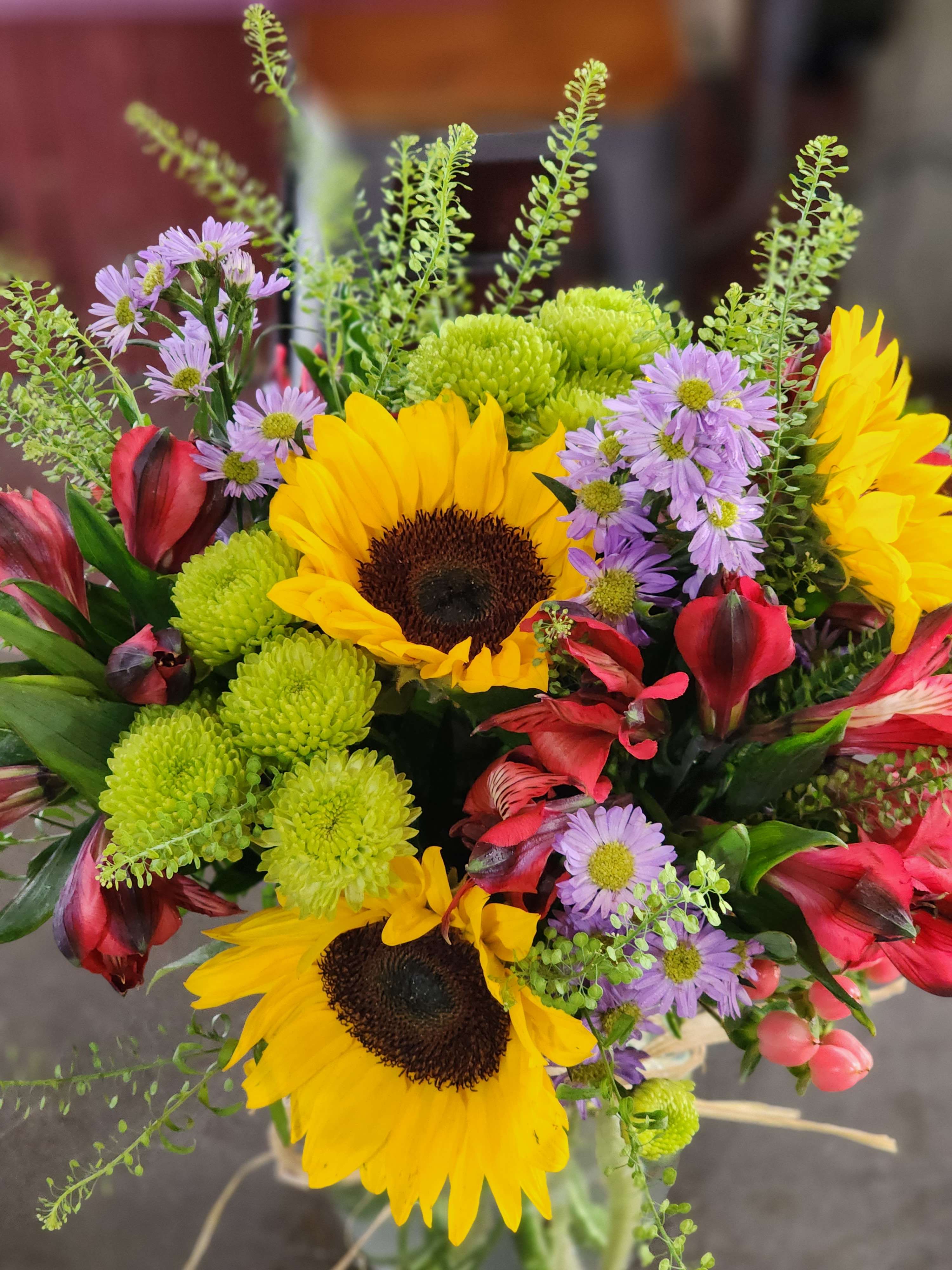Bouquet with sunflowers, purple daisies, red alstroemeria, and green chrysanthemums