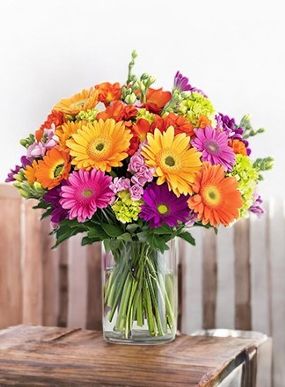 Colorful gerbera daisy bouquet in a clear glass vase