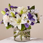 Beyond Blue - BEYOND BLUE BOUQUET There is something about the shade of blue that brings a sense of calmness and serenity. Our Beyond Blue bouquet is designed with billowing white blooms and pops of bold florals to deliver just the right sentiment for any reason.  Please Note: The bouquet pictured reflects our original design for this product. While we always try to follow the color palette, we may replace stems to deliver the freshest bouquet possible, and we may sometimes need to use a different vase. DETAILS The Deluxe Bouquet is approximately 14"H x 13"W. Designed by florists, ready to display. For long–lasting blooms, replace the water daily. We suggest trimming the stems every couple days. Pet Safety Precautions: This bouquet or plant may include flowers and foliage that are known to be toxic to pets. To keep them safe, be sure to keep this arrangement out of your pet's reach. BLOOM DETAILS Daisy Lily Rose