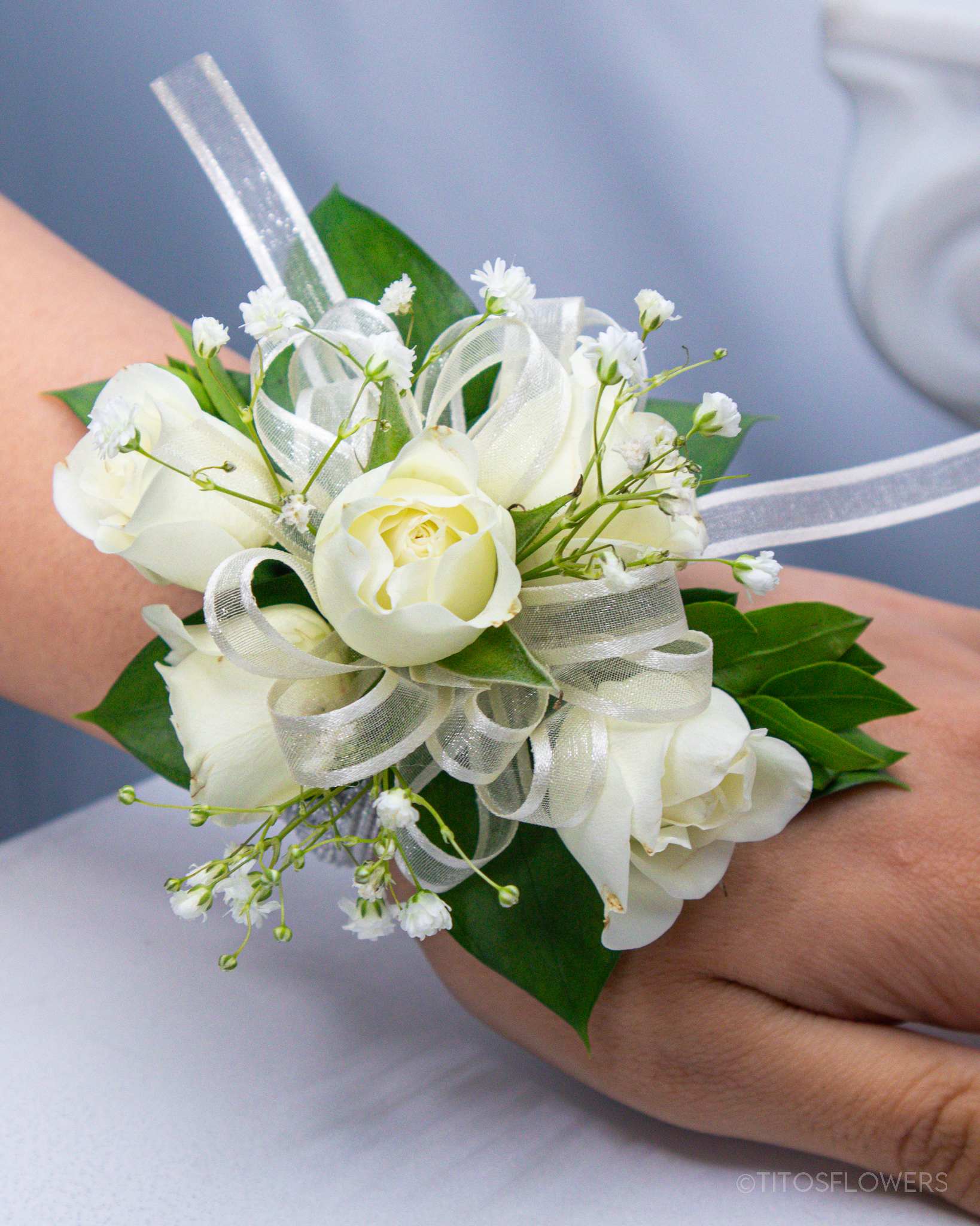 White rose wrist corsage with ribbon and baby's breath