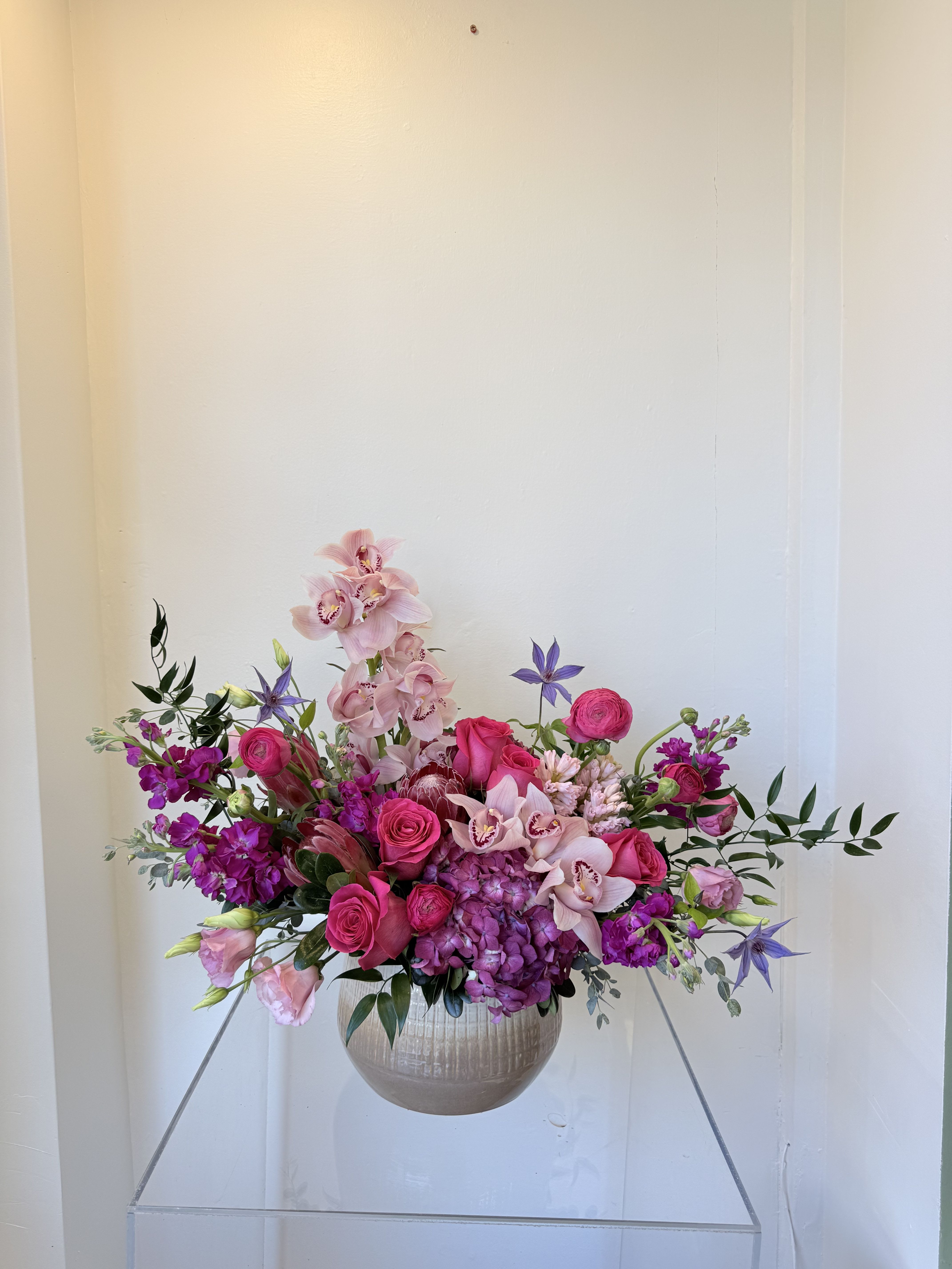 A mother's garden - Celebrate Mom with a breathtaking garden-style arrangement designed to express love, gratitude, and beauty. Featuring lush pink hydrangeas, premium roses, elegant orchids, and seasonal blooms in radiant shades of blush and fuchsia, this design is full of movement and modern sophistication. A truly unforgettable statement—just like her.