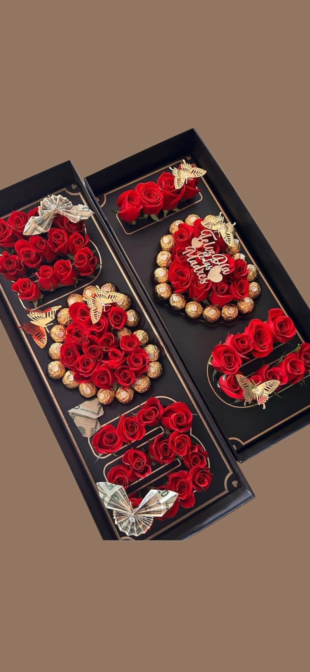 Mom I love you  - Bold red roses arranged in sleek black gift boxes create a dramatic, love-themed flower arrangement perfect for Mother's Day, anniversaries, or to say "Mom, I love you" with flair. The contrast of deep red blooms against matte black or pink or white  presentation boxes gives a luxury, romantic impression that makes the recipient feel truly celebrated and seen.  Red roses arranged in letter-shaped compartments, surrounded by rings of Ferrero Rocher chocolates for an indulgent touch. Decorative butterfly picks and folded cash bows add a personalized, celebratory accent; the overall palette reads red, black, and mixed accents for visual richness. This compact, gift-ready set arrives arranged and ready to present - an elegant combination of flowers, treats, and keepsake boxes that turns a thoughtful message into a memorable moment.