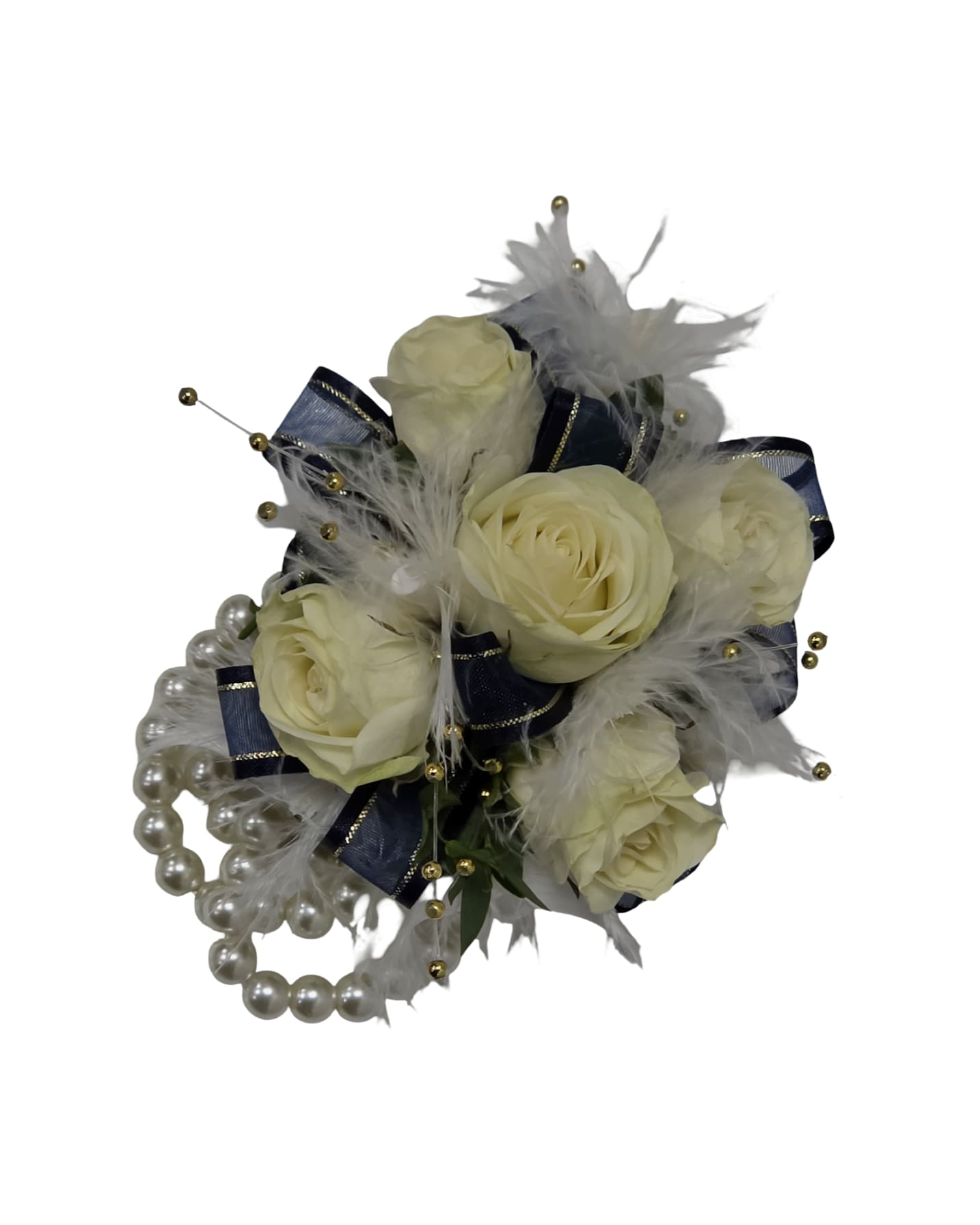 The Royal Evening Wristlet - Cream-white spray roses gathered into a compact, formal wristlet make an elegant statement for prom or any dressy celebration-the kind of floral accessory that makes the person wearing it feel noticed and cherished. The arrangement reads romantic and refined, with the pale roses set against navy ribbon loops for a striking light‑on‑dark contrast that complements evening attire and classic color palettes.  Soft white feathers and cascading pearl bead strands lend texture and a slightly ornate finish, while gold bead picks add tiny flashes of warmth and sparkle. The wristlet is finished on a white pearl wristband, creating a polished, wearable piece that sits comfortably on the wrist. Ideal as a prom corsage, bridesmaid accent, or a special gift for someone you want to honor, it arrives ready to wear and adds a touch of vintage glamour to any formal look.