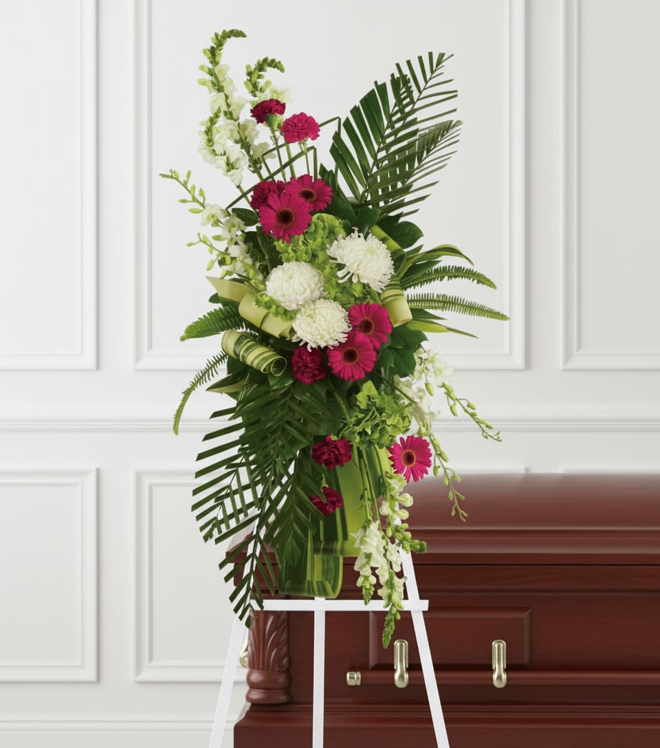 Gerberas and Palms Spray - Convey your respect and admiration with this spray of striking red and white funeral flowers. Red gerberas and carnations complement white orchids, snapdragons and chrysanthemums, all set against the deep greens of tropical palm leaves.
