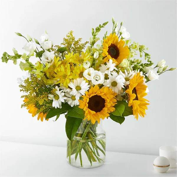 Hello Sunshine Bouquet Exquisite - Give a dose of sunshine in bloom. This stunning bouquet is teeming with rays of sunflowers, textured snapdragons and darling daisy poms to deliver the perfect pick–me–up for an occasion or as a treat to yourself.