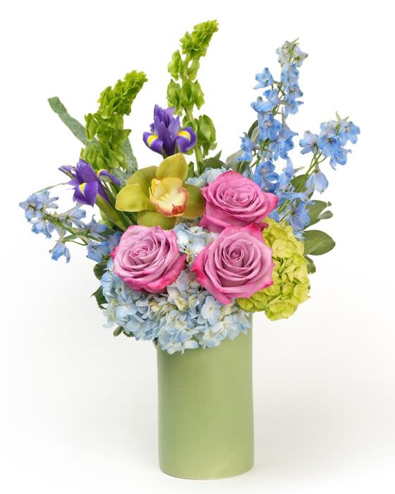 Iris and Sky - Soft roses and blue blooms with fresh greenery, arranged in a light, airy design inspired by sky - toned garden beauty.