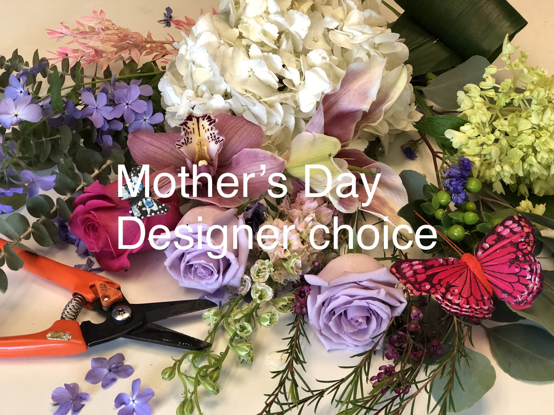 Mixed floral arrangement with roses, orchids, hydrangea, and butterflies