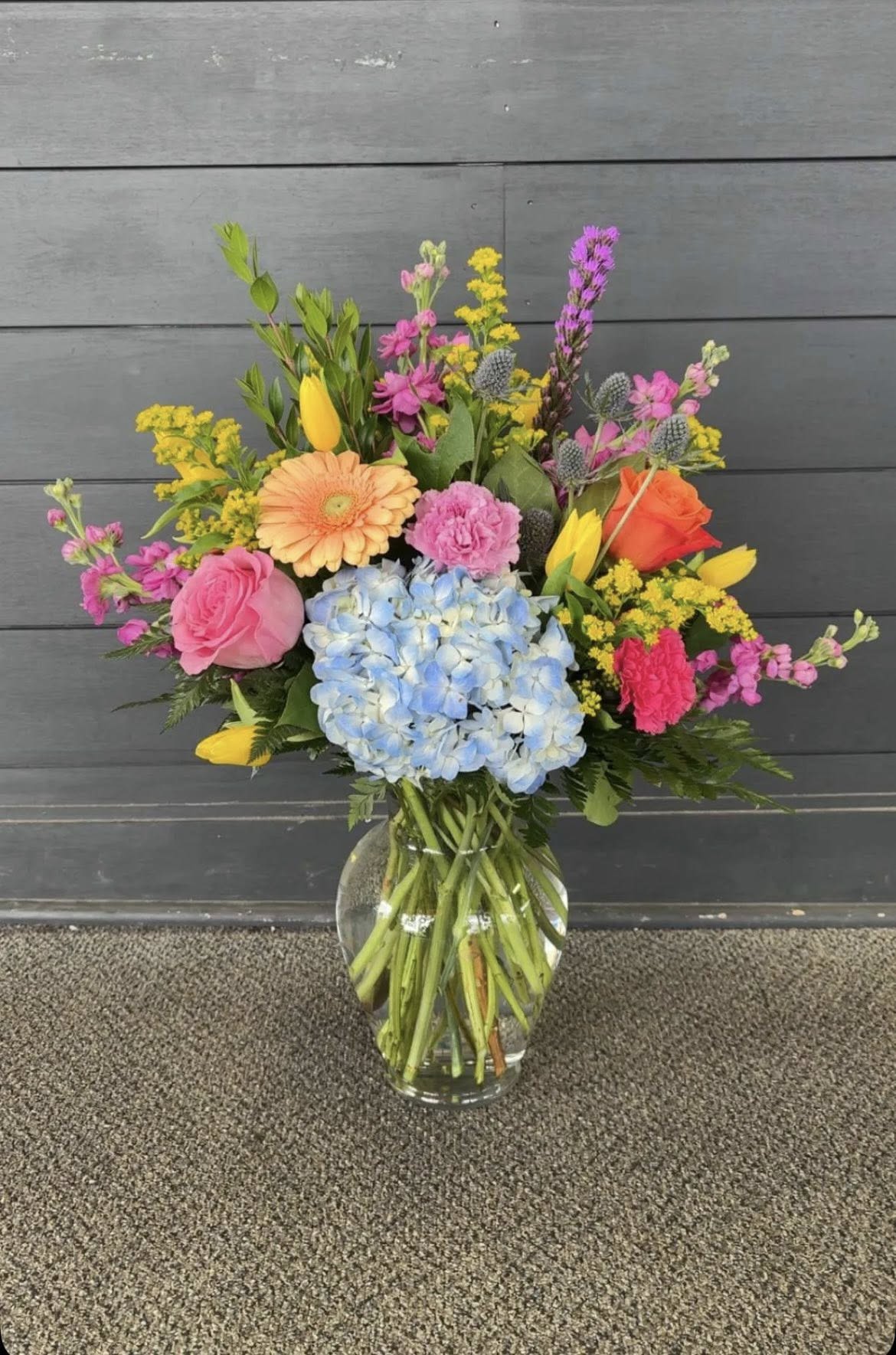 Neon Dream - This neon vase is made up of Hydrangeas, Roses, Gerbera Daisys, Carnations and more