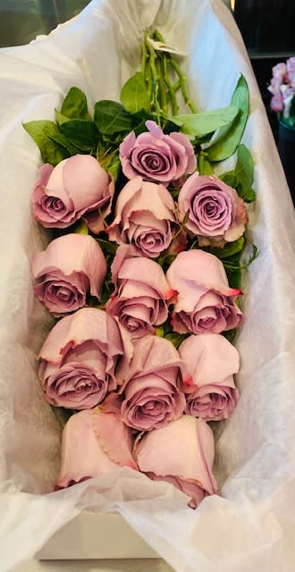 Bouquet of pale pink roses wrapped in white paper