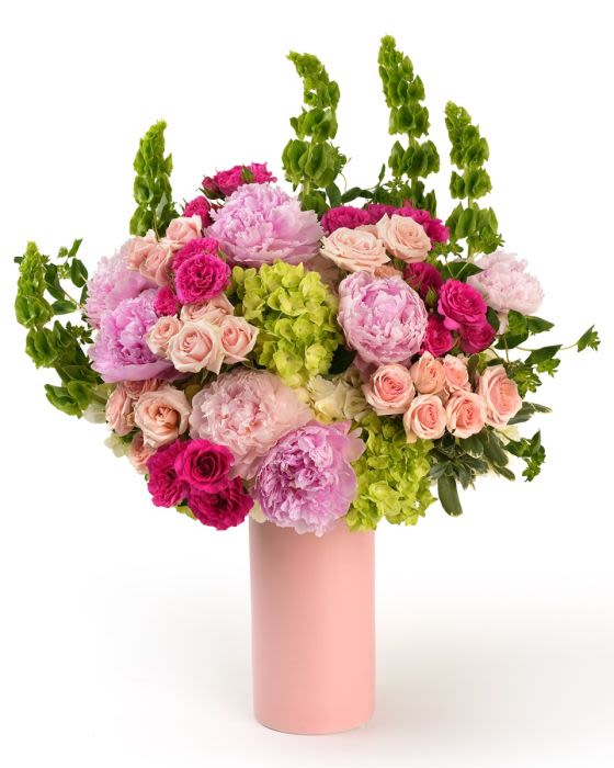 Reffled Elegance - Ruffled blooms in soft pinks with vibrant accents, artfully arranged with lush greenery for a polished garden feel.