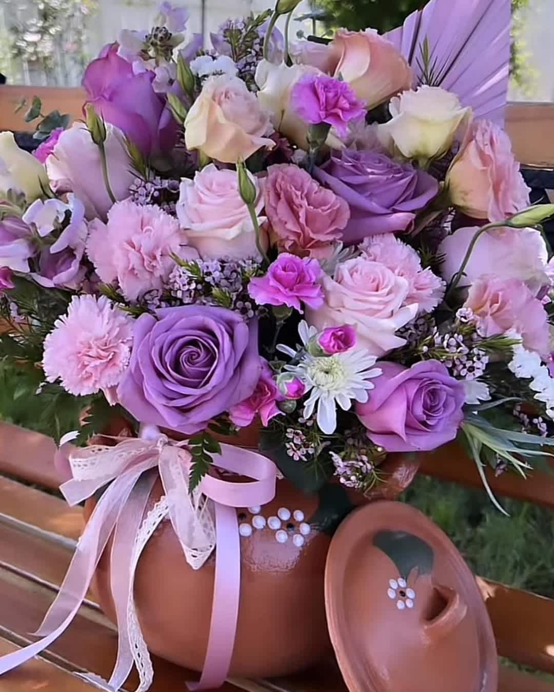 Lavender and pink rose bouquet in a terracotta pot with a ribbon bow