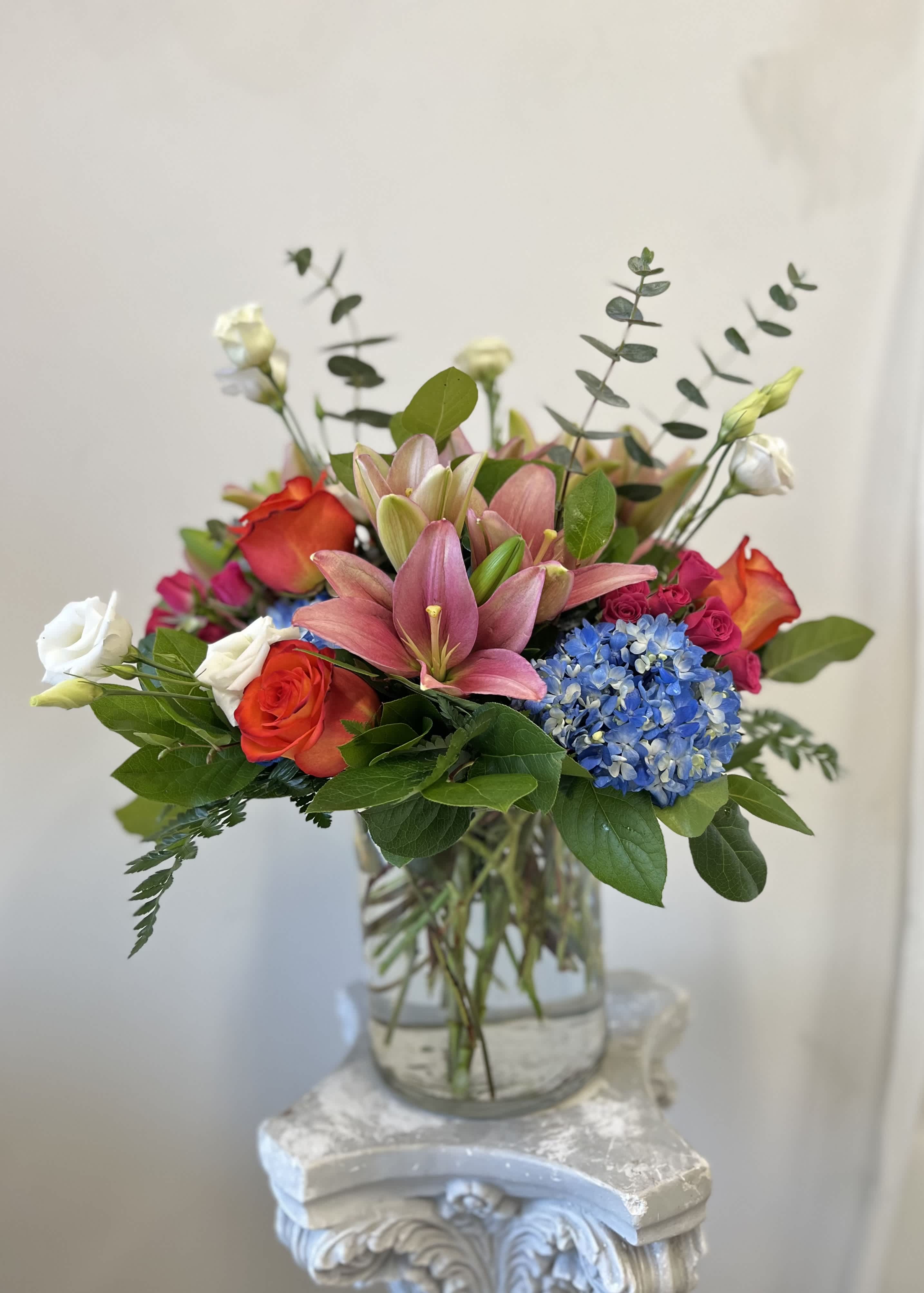 Casablanca Bouquet by Westford Florist Art by Veny - Elevate your gifting experience with the Casablanca Bouquet by Westford Florist Art by Veny—a captivating floral arrangement designed to leave a lasting impression. This exquisite bouquet marries the serene beauty of lush blue hydrangeas with the vibrant energy of orange spray roses, creating a harmonious blend that embodies elegance and warmth. Ideal for any occasion, this stunning selection ensures that your thoughtful gesture will not only brighten someone’s day but also resonate in their memory for years to come. Make every moment extraordinary with the irresistible charm of the Casablanca Bouquet. So go ahead and surprise your loved ones with this unforgettable gift that will leave them speechless. Whether it's for Valentine's Day, Mother's Day or simply just because - our Casablanca Bouquet is the ultimate way to show someone how much you care. Let these gorgeous blooms serve as a reminder of your love as they continue to bloom before their eyes. Don't hesitate - order your Casablanca Bouquet by Westford Florist Art by Veny today and elevate your gift-giving game! With its vibrant colors and romantic allure, this bouquet is bound to sweep anyone off their feet.