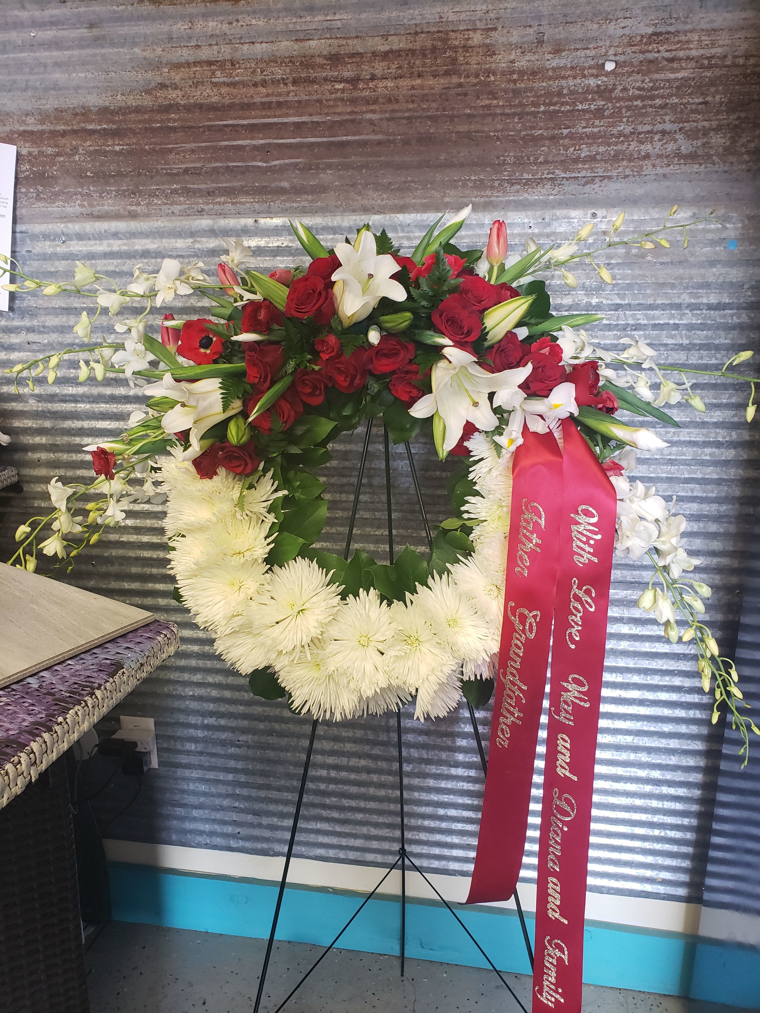 Red and white Wreath  - An elegant Tribute with red and white flowers   Script ribbon is custom and a extra fee.  
