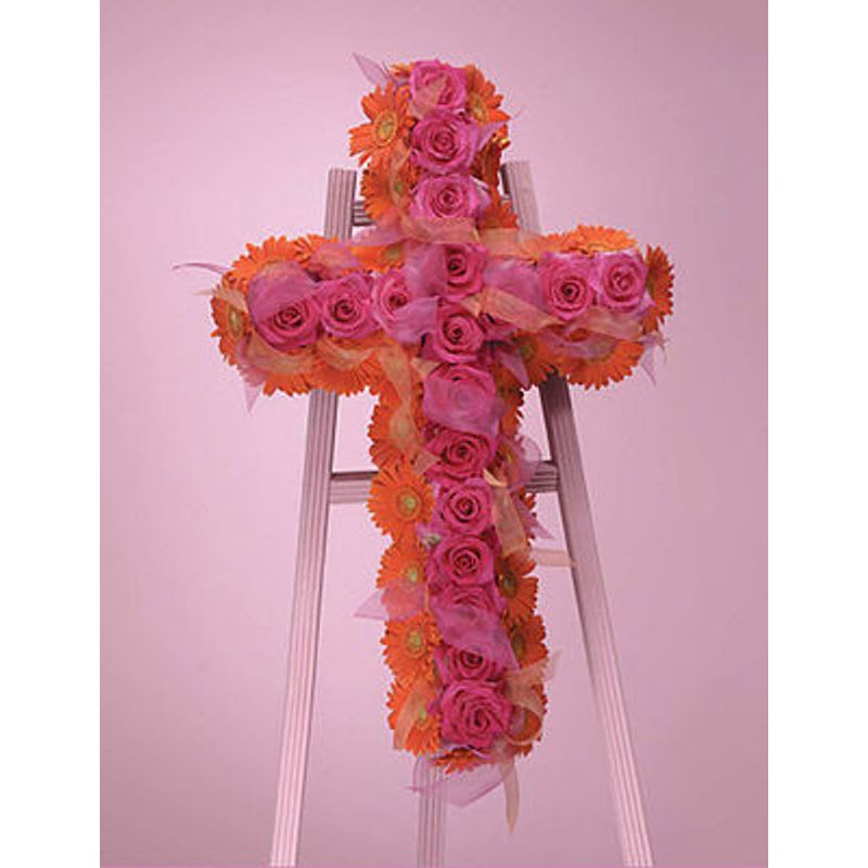 Vibrant Cross - Orange gerbera daisies and hot pink roses softened by the sheer ribbon.