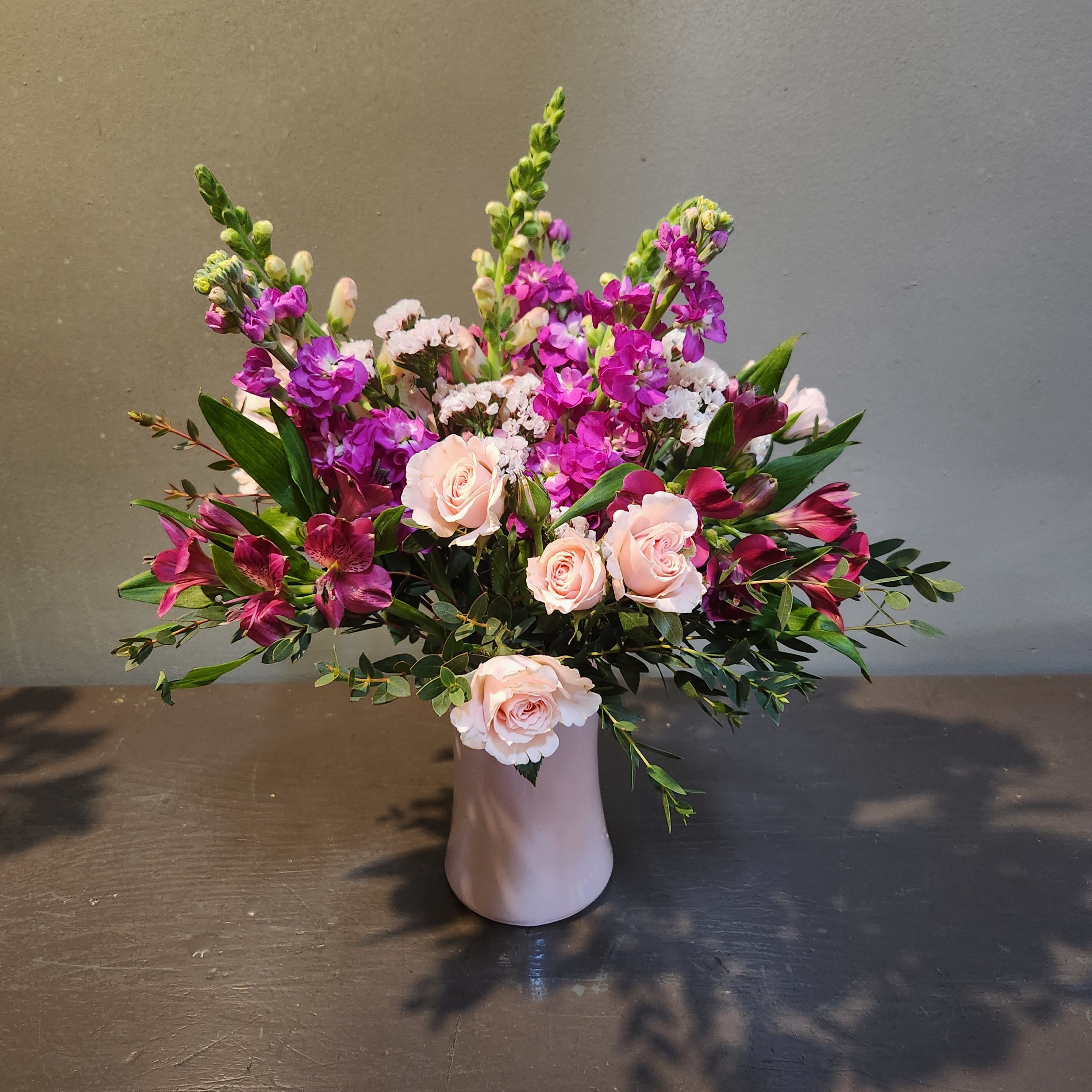 Spring Serenity - A cheerful, pink bouquet to celebrate Spring!  Arrangement measures 18" tall and 13" wide and arrives in a pink glass vase.