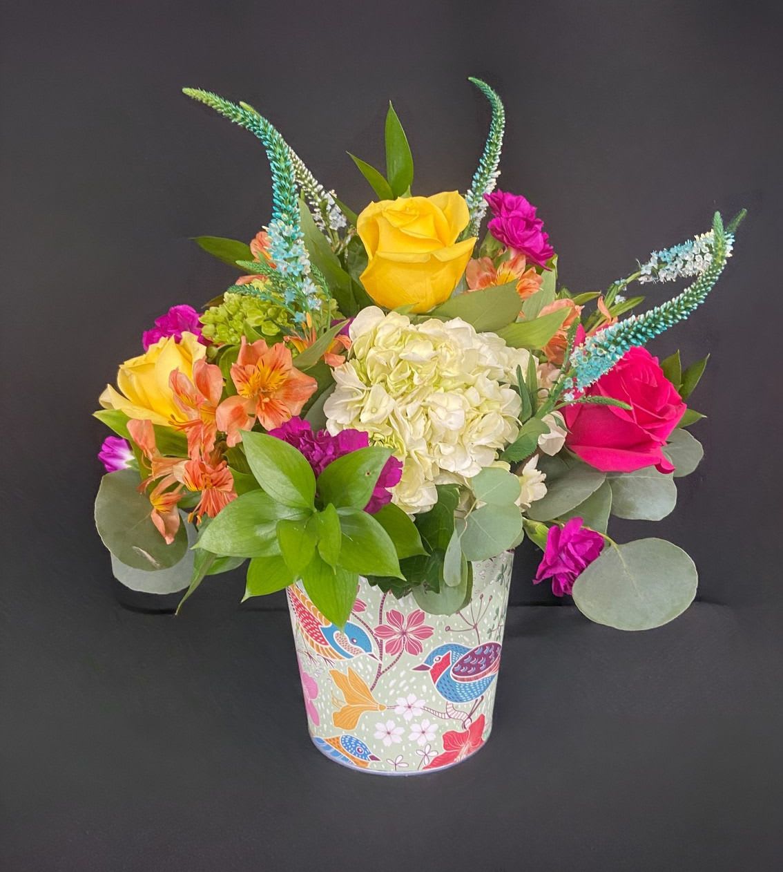 Blooms of a Feather - This vibrant arrangement is a cheerful garden party in a cup! It’s a bold, colorful mix that feels both wild and thoughtfully gathered.