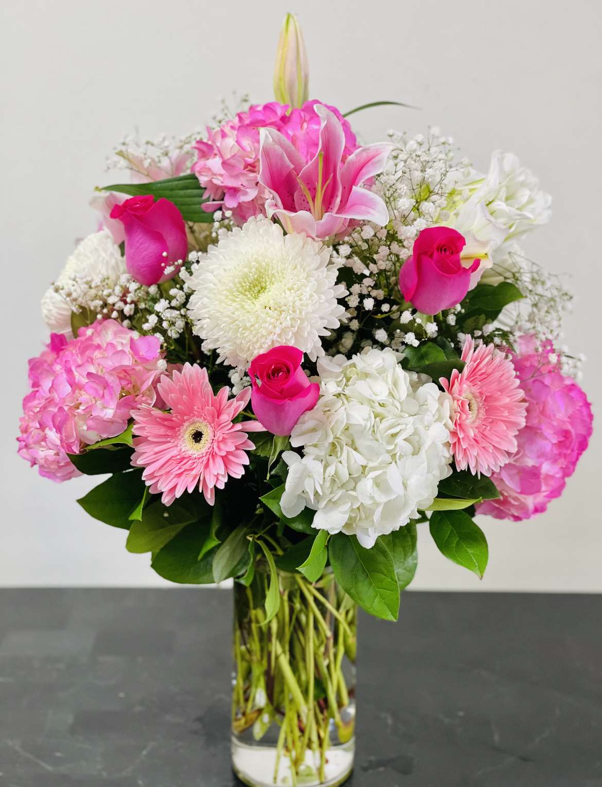 Pink and white mixed flower bouquet in a clear glass vase