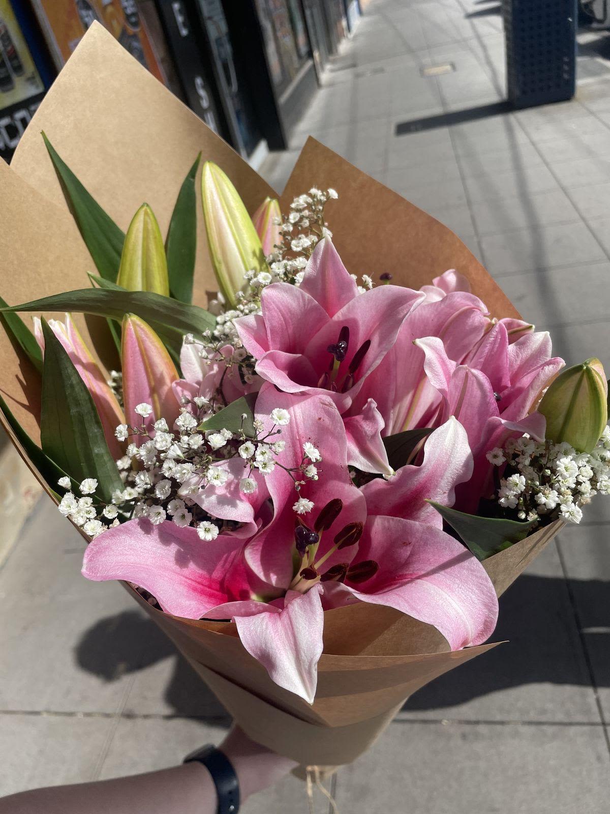 Pink Lilies Bouquet- 4 stems - Beautiful pink lilies arranged in 4 stems with delicate Korean paper and cloud-style wrapping. Lilies may arrive slightly closed depending on freshness in-store, but they will open beautifully at home. Quality and value remain the same, perfect for gifts or home décor.”
