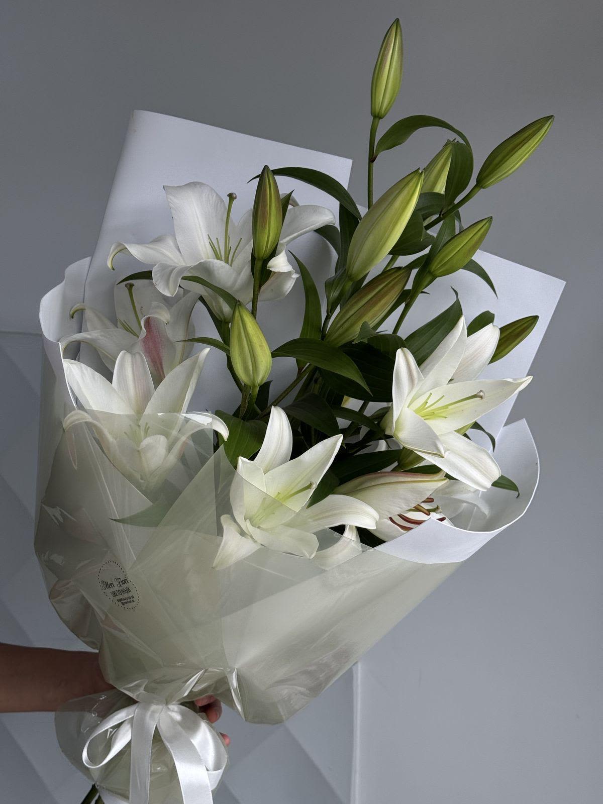 white lilies bouquet-4 stems - Elegant white lilies arranged in 4 stems with soft Korean paper and cloud-style wrapping. Stems may arrive partially closed depending on store freshness, but they will bloom beautifully. Same quality and value guaranteed. Ideal for gifts, celebrations, or home décor.