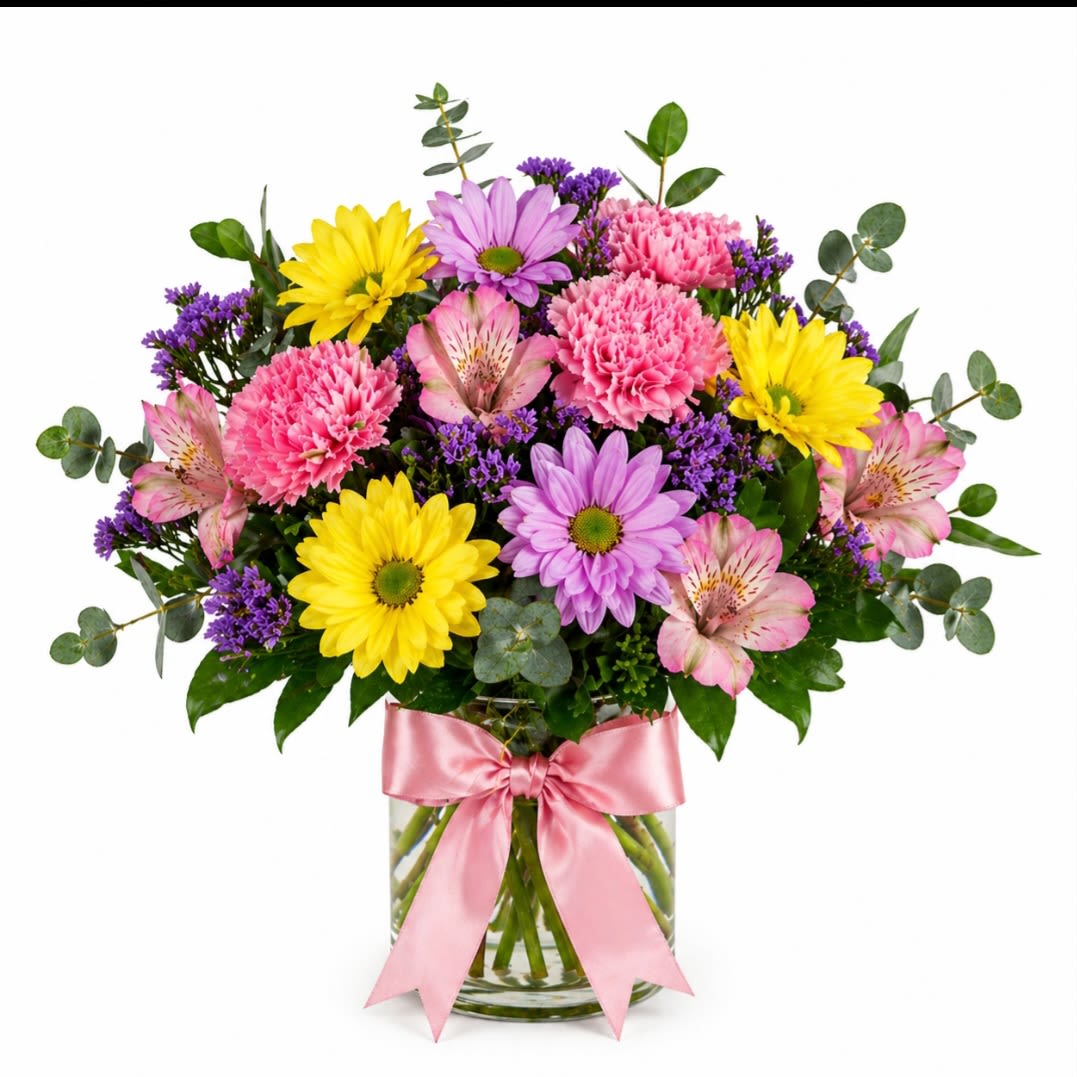 Sunshine blush Bouquet  - A bright and cheerful everyday arrangement designed to make someone smile. Featuring sunny yellow daisies, soft pink carnations,lavender mums,delicate pink alstromeria, pops of purple statice, fresh greenery and a satin pink bow.