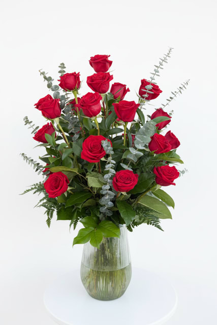 Forever Love 24 - Celebrate love in its most classic form with this breathtaking arrangement of two dozen fresh red roses, elegantly arranged in a clear glass vase with premium greenery. Designed to impress, this bouquet delivers a rich, romantic look that makes it perfect for anniversaries, birthdays, or just because. Each arrangement is handcrafted with care to ensure a beautiful presentation and long-lasting freshness. 