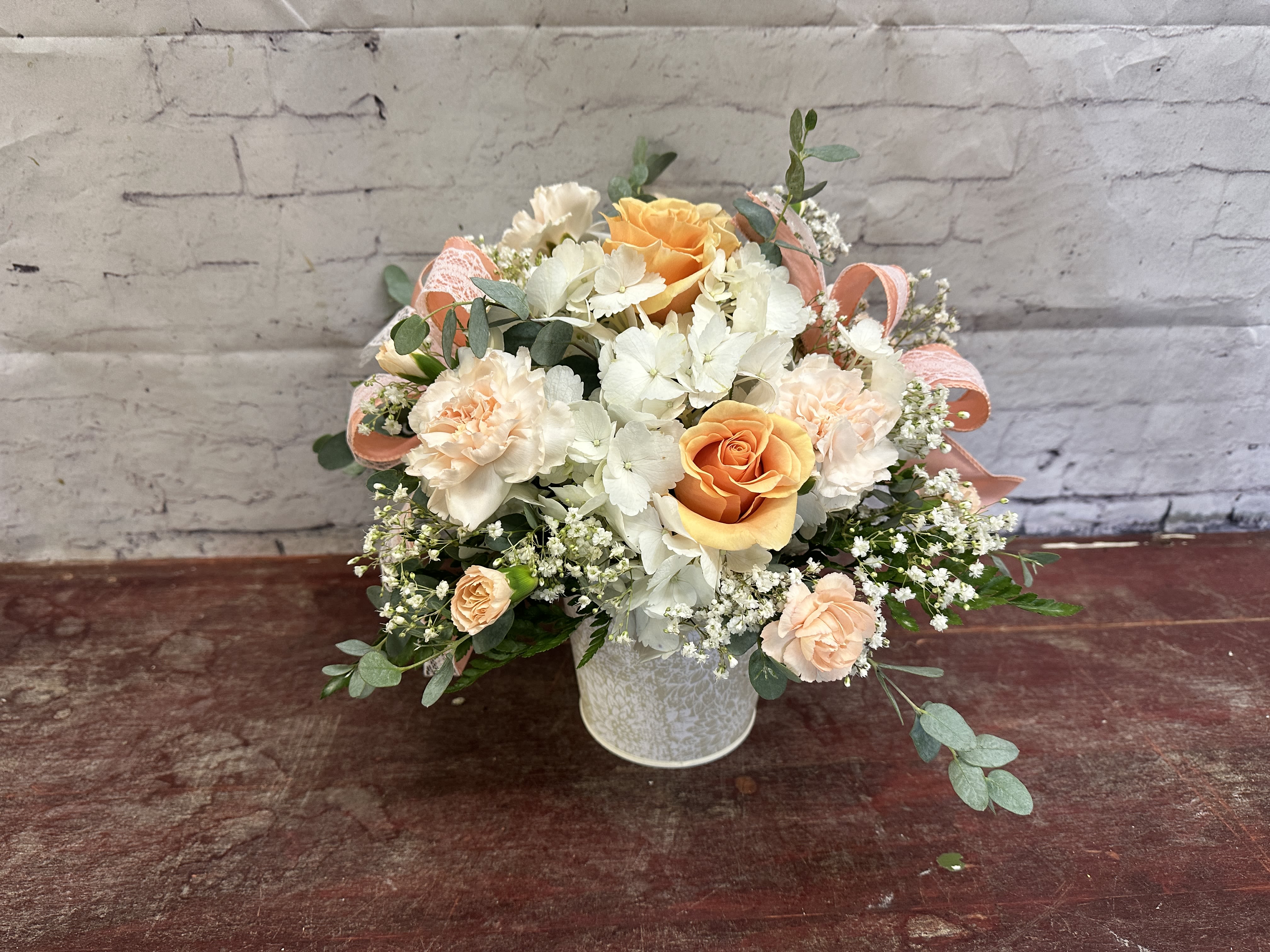 Sweet as peaches  - Peach roses with carnations and filler in a white patterned tin, finished with a lace ribbon.