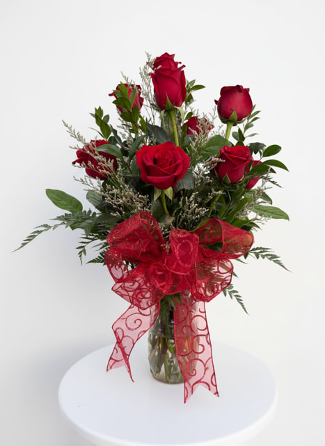 Classic Dozen Roses - A timeless arrangement of 12 fresh red roses in a glass vase with greenery and a decorative ribbon. Perfect for romantic occasions or a simple, meaningful gift.