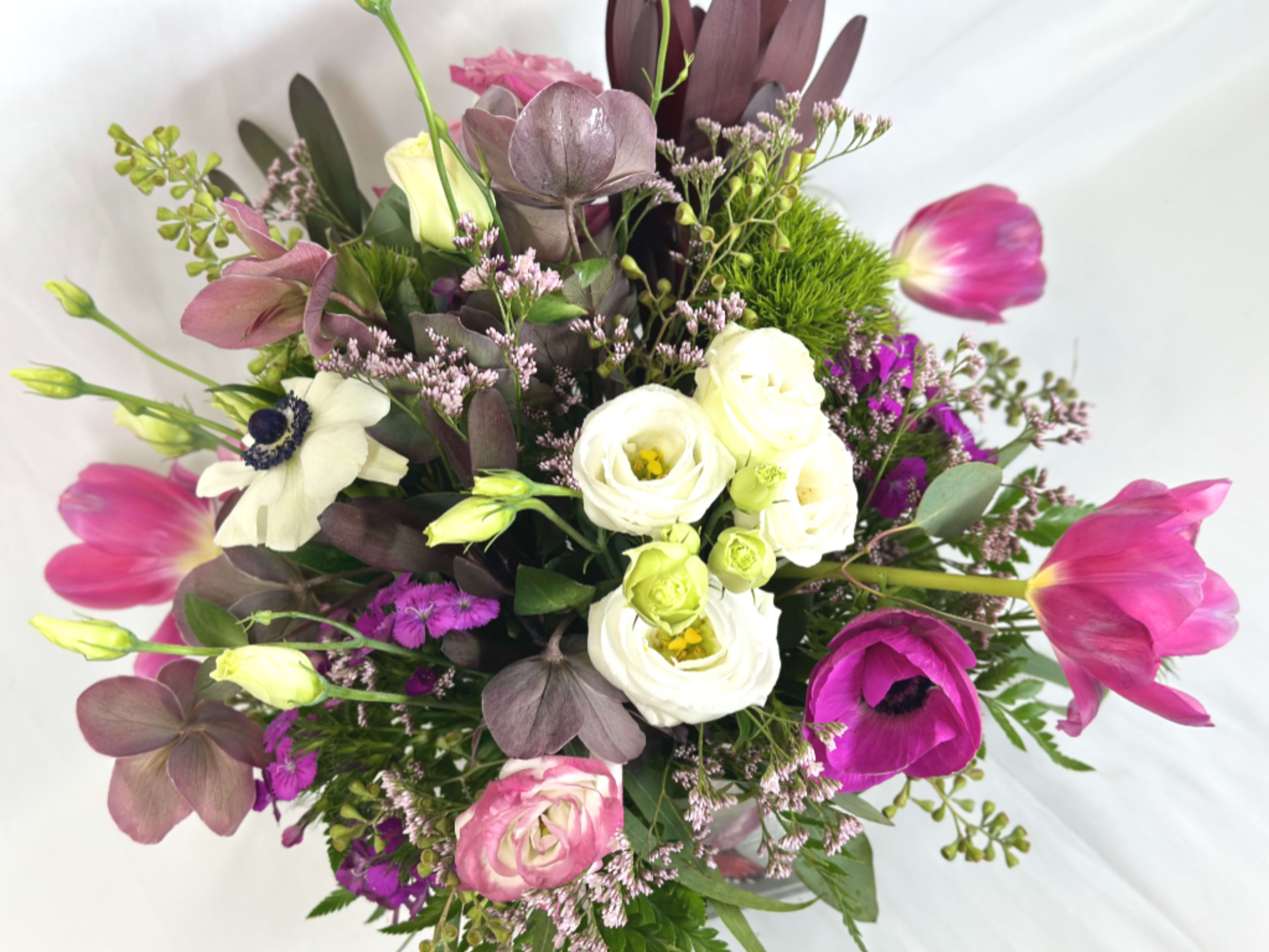 Hummingbird Garden - This delightful design features a large array of beautiful flowers in a keepsake hummingbird vase. The small cube can be reused as a vase, or a a special spot for your little treasures. If the featured flowers of this Leary's exclusive arrangement are unavailable, we will design your gift using the freshest available blooms of equal or greater value